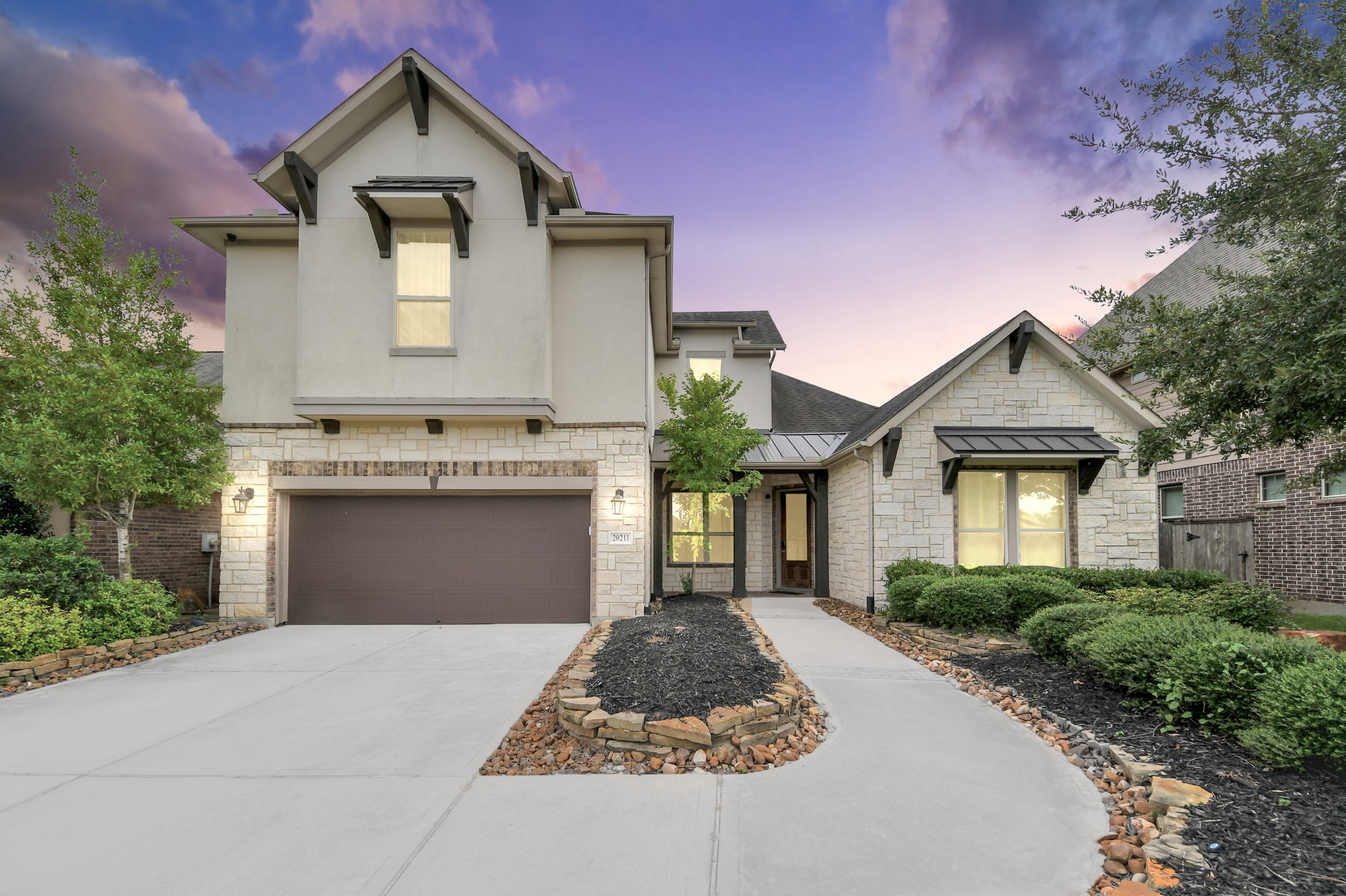 Striking front elevation showcased at twilight with warm exterior lighting and an inviting covered entry. Striking front elevation showcased at twilight with warm exterior lighting and an inviting covered entry.