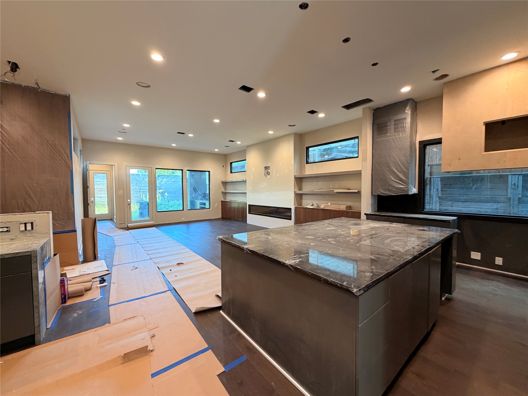Large Family area with island kitchen, bar area to the left and enclosed wine room