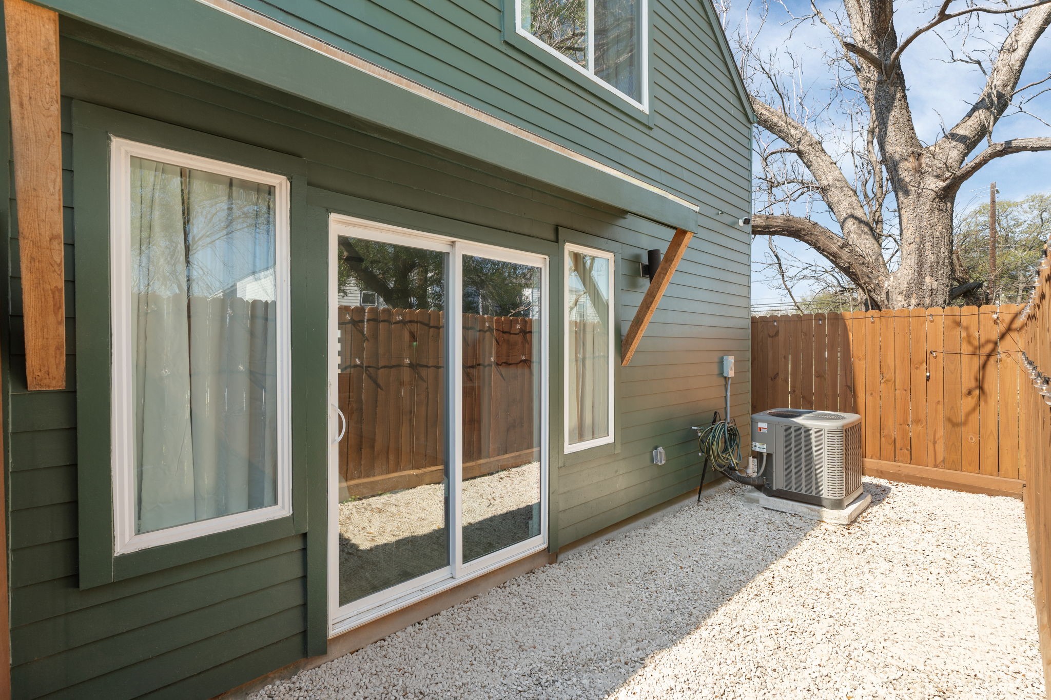 backyard space, access is through the bedroom downstairs or through a side gate