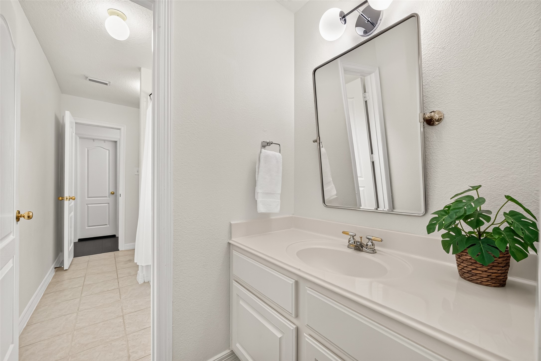 Shared Jack and Jill bath showcasing independent vanity and custom Mirror.