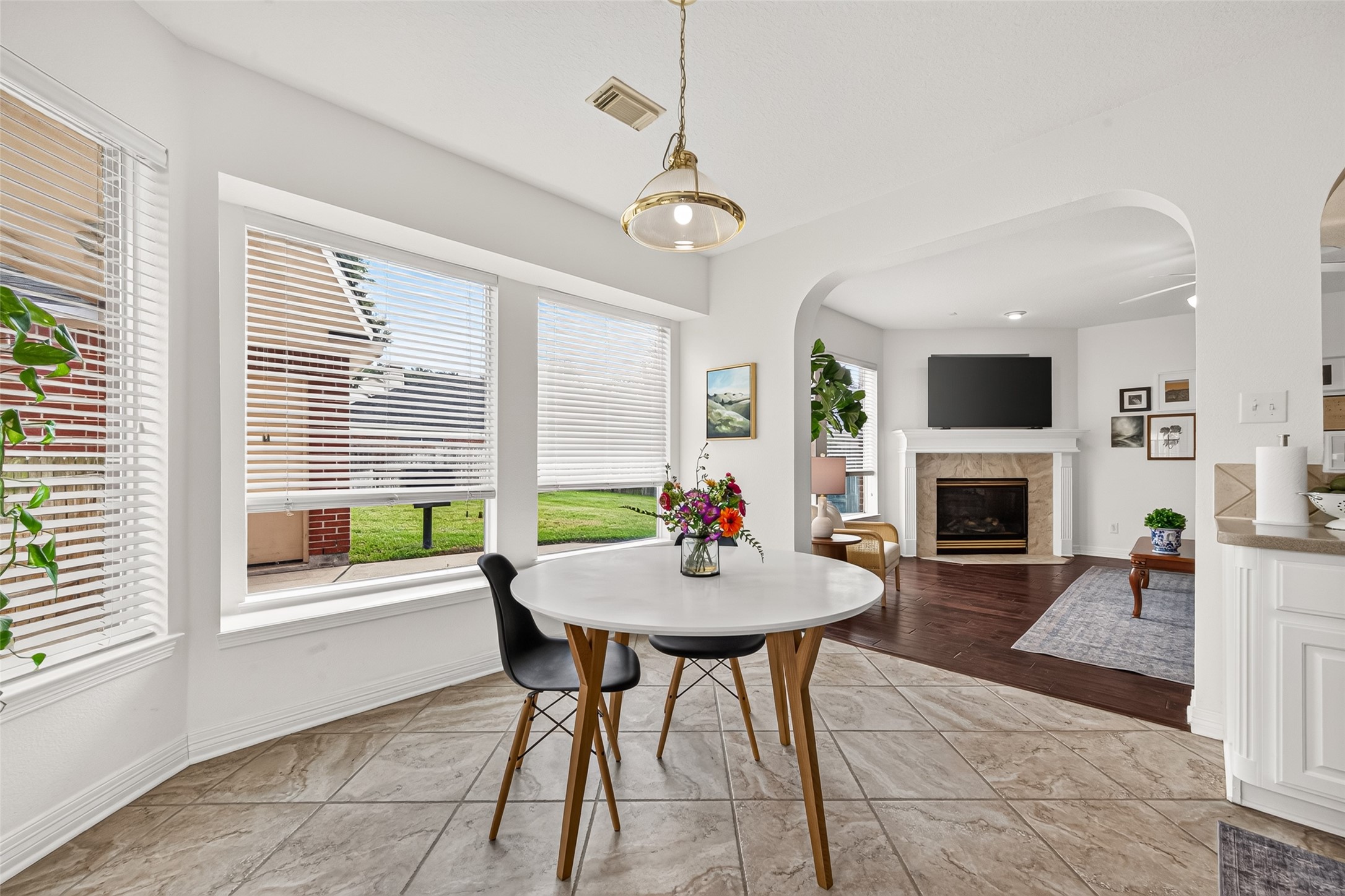 Bright and inviting breakfast area overlooking the backyard, seamlessly connecting to the living room.