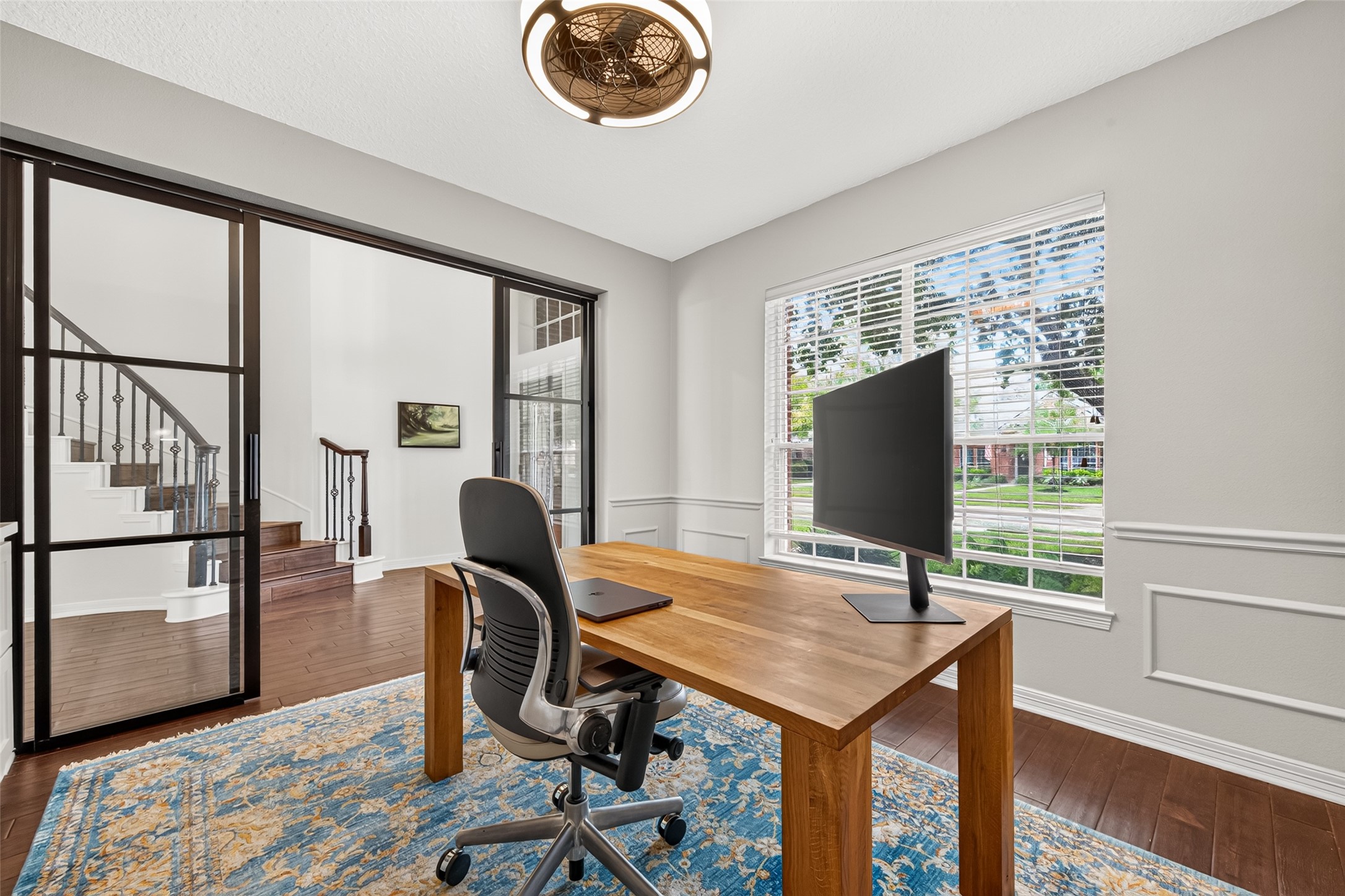 Private study featuring natural lighting, elegant glass doors, and rich wood flooring, offering a perfect workspace with a view. Private study featuring natural lighting, elegant glass doors, and rich wood flooring, offering a perfect workspace with a view.