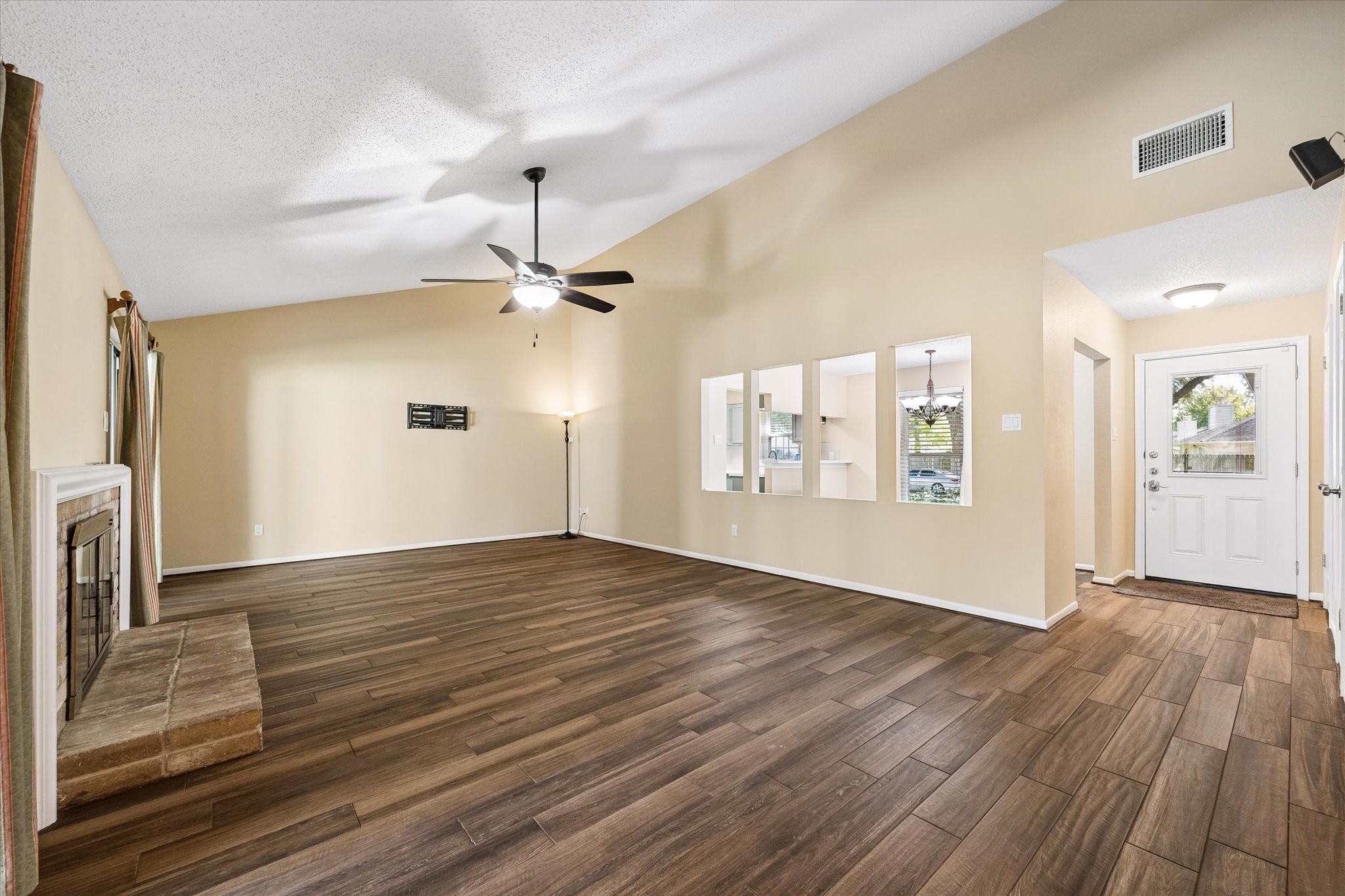 Make yourself at home in this inviting living space, where a fireplace and open layout set the stage for relaxing evenings and entertaining.