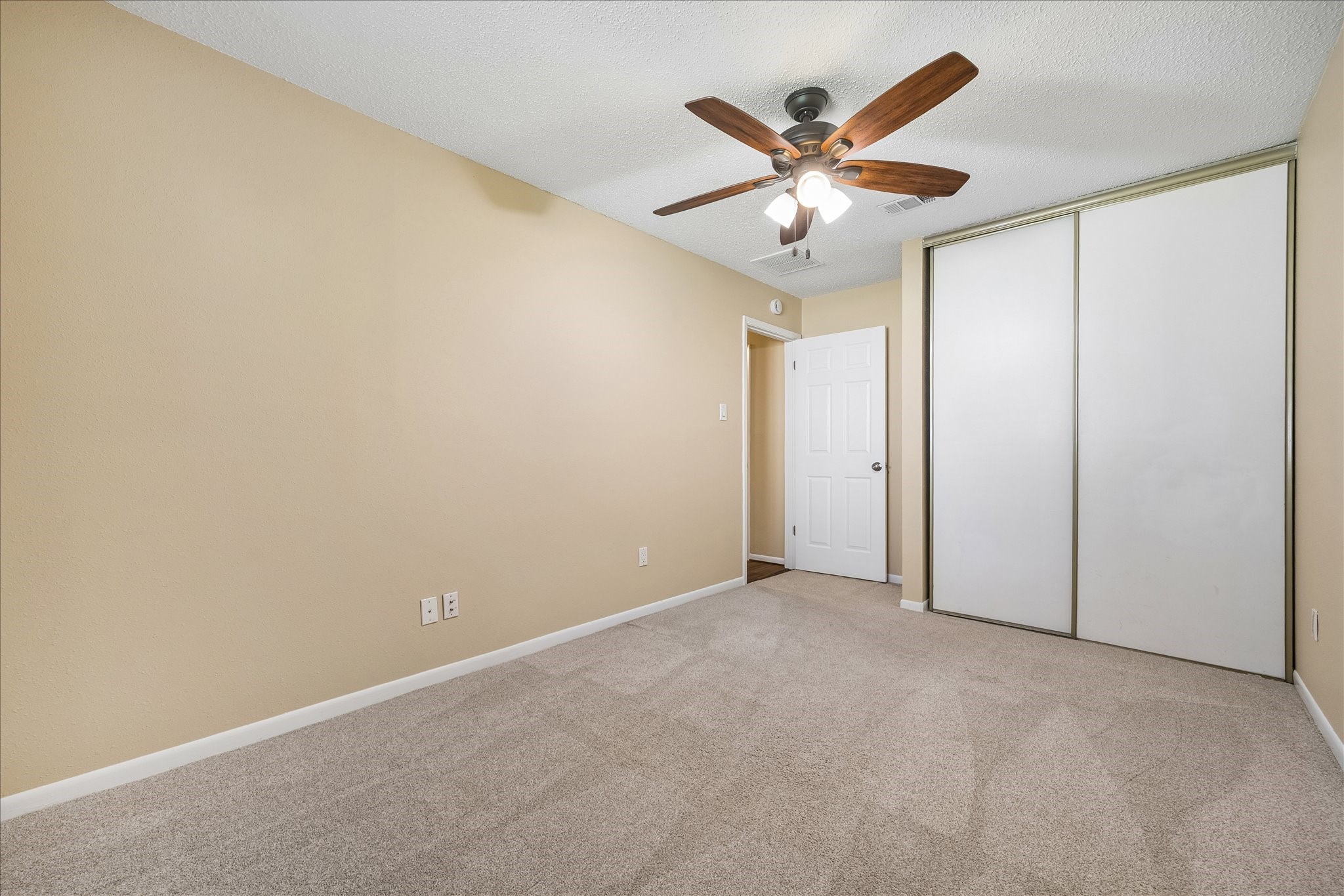 Enjoy a comfortable bedroom with a spacious sliding-door closet and room to arrange your furnishings just the way you like.