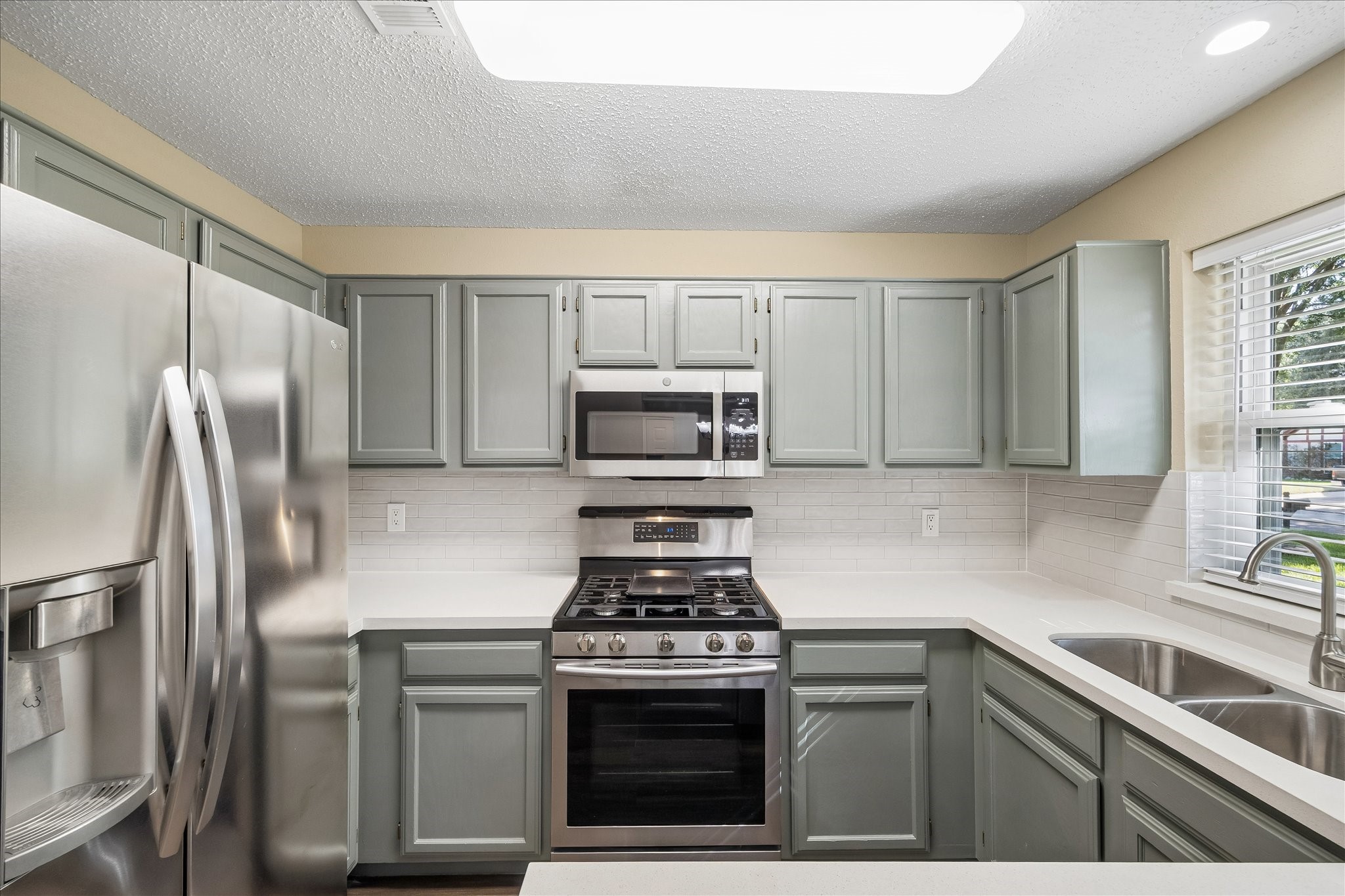 Fresh finishes and a practical layout make this updated kitchen a wonderful place to prepare meals and enjoy everyday moments.