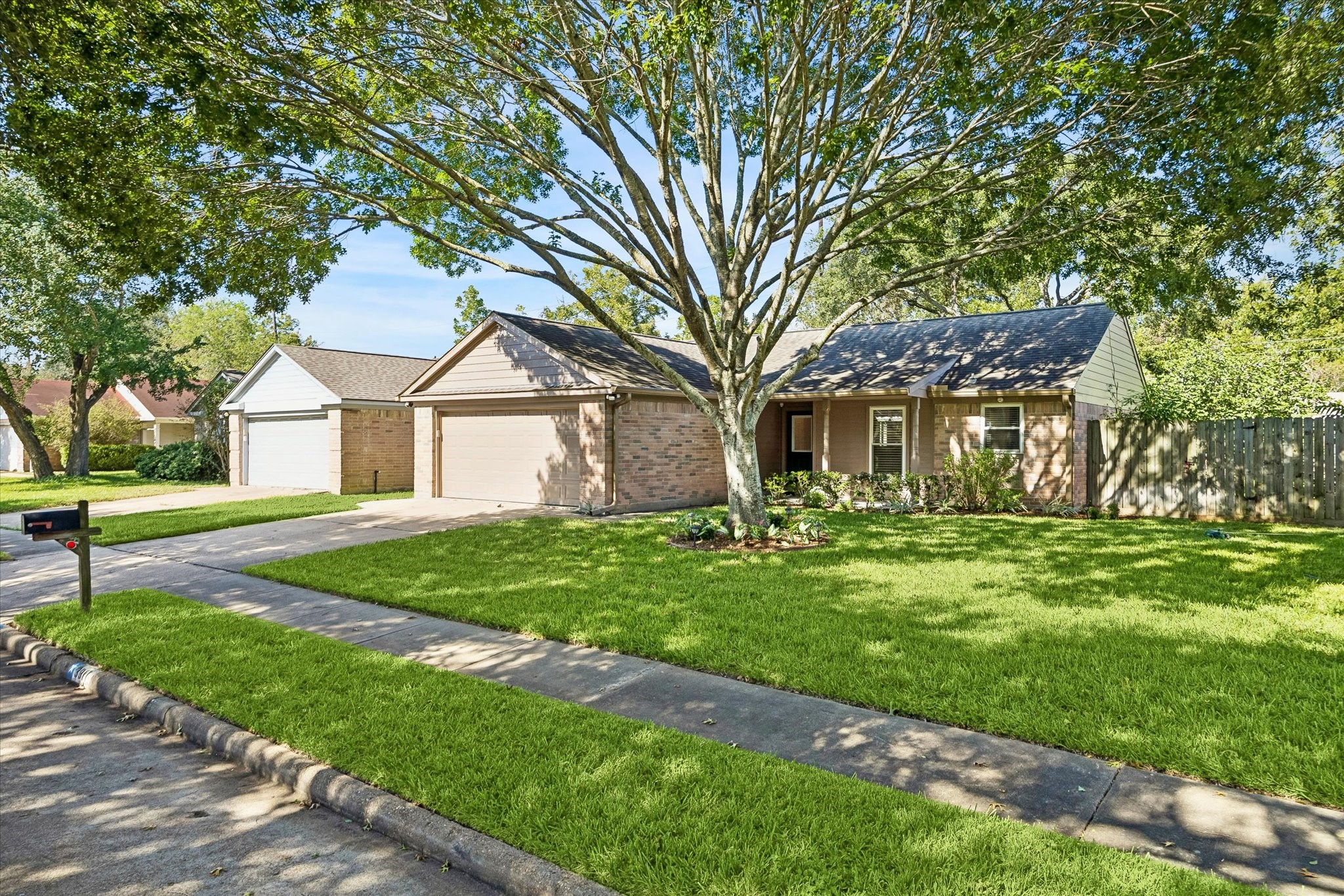 Enjoy the charm of an established neighborhood with mature trees, a green lawn, and a home that feels inviting from the street