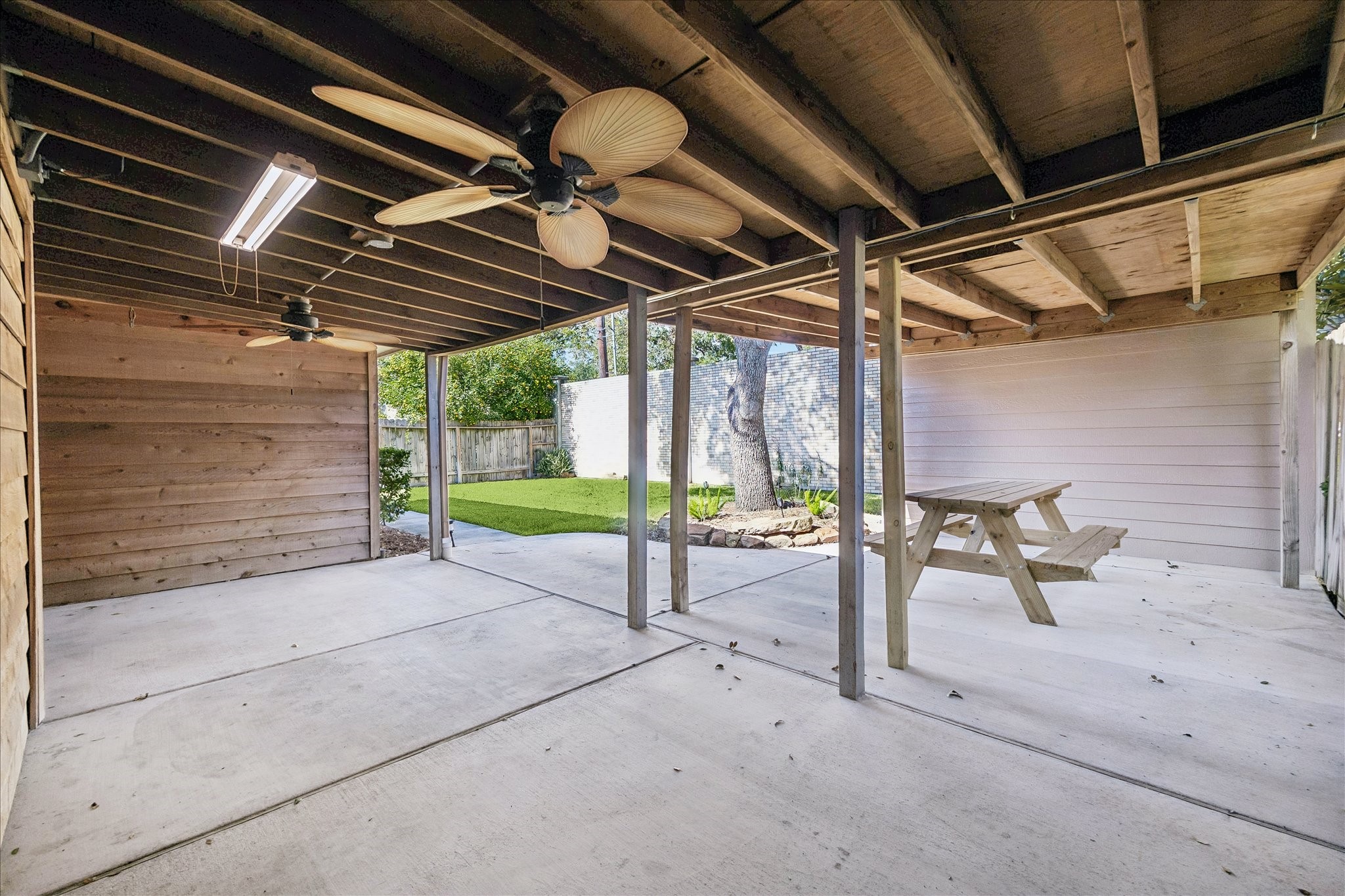 Make the most of outdoor living with a spacious covered patio featuring overhead lighting, a ceiling fan, and room to gather.