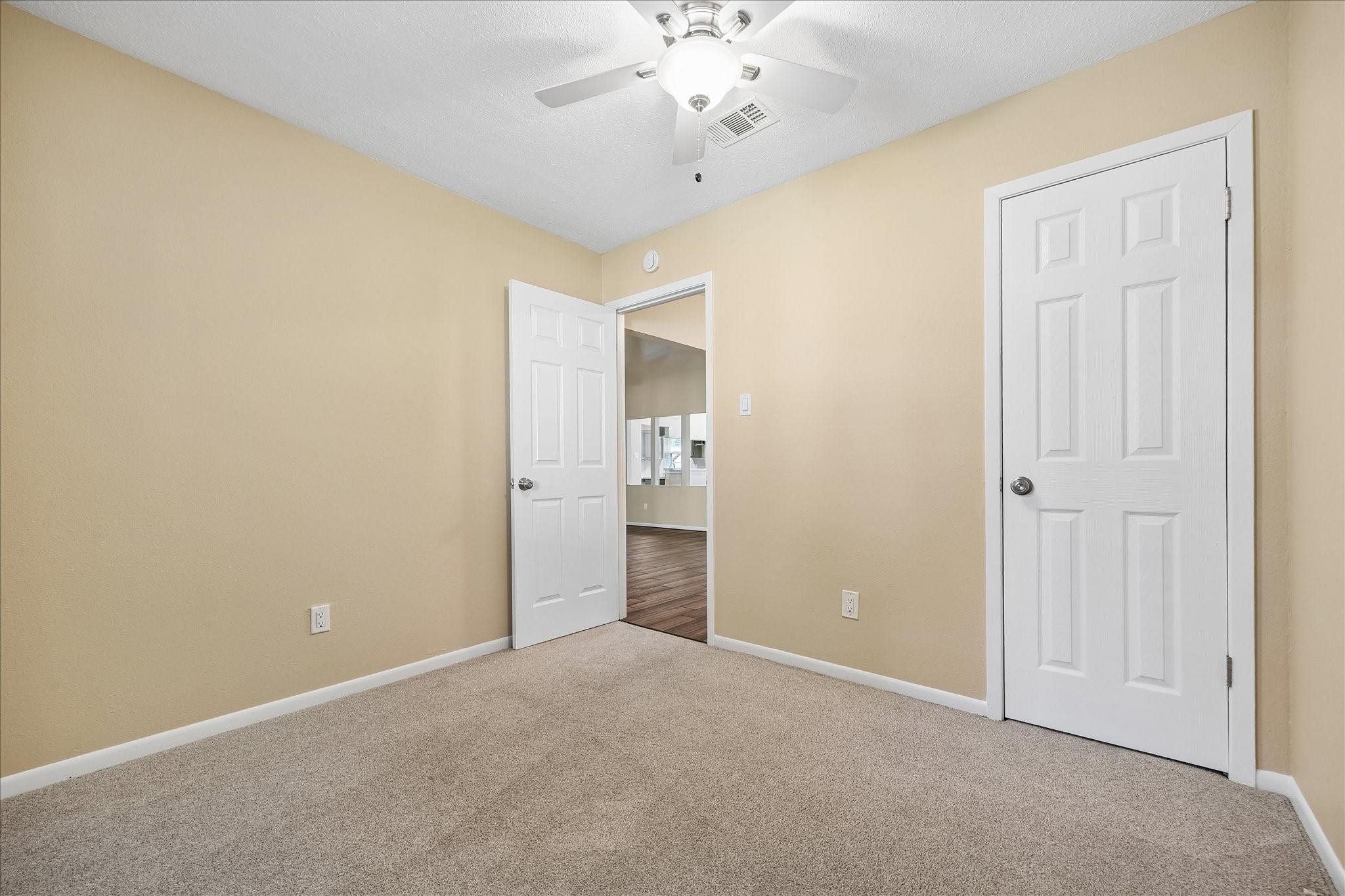 A versatile bedroom with a convenient closet and neutral finishes offers a blank canvas for your personal style.
