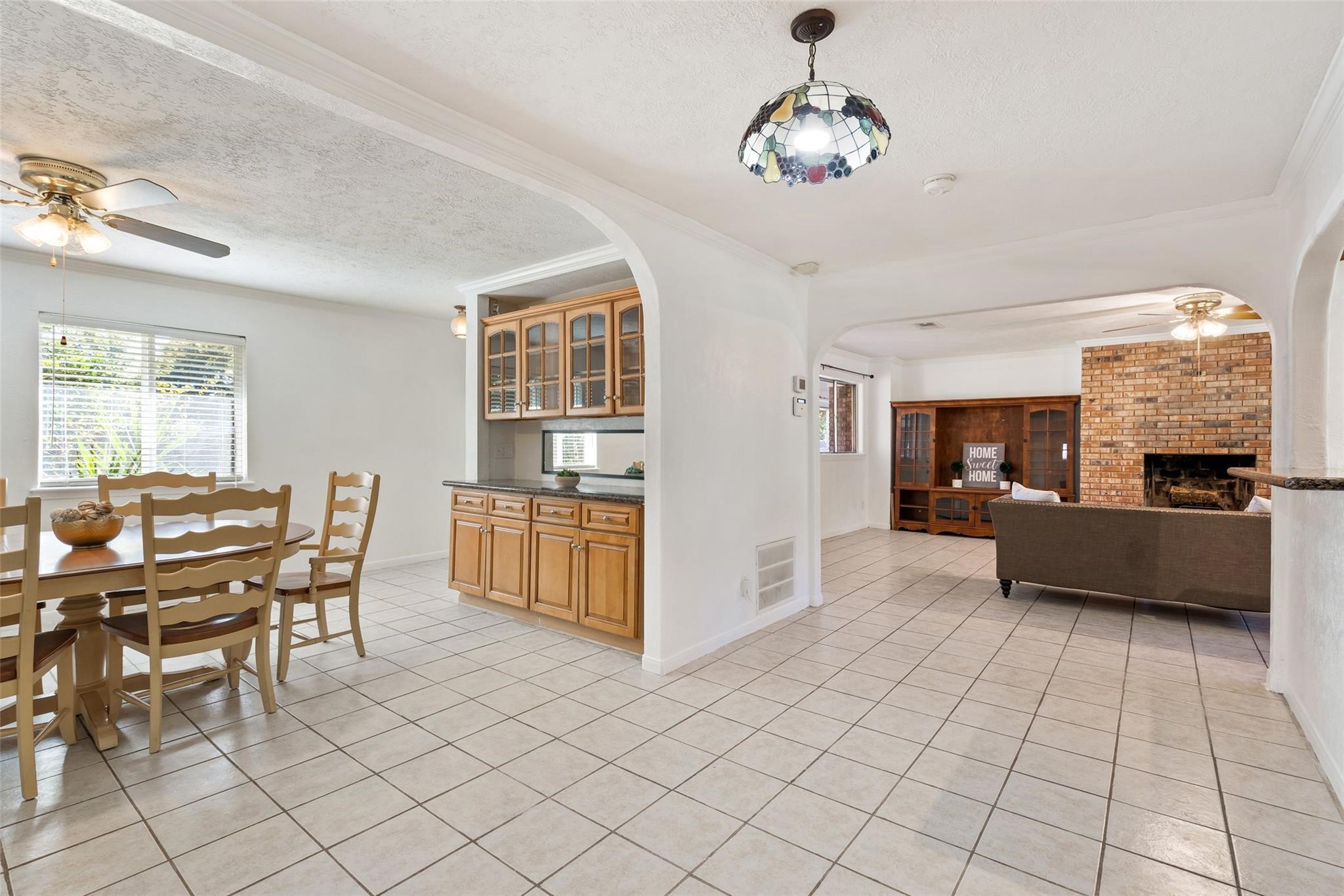 An extensive dining room is on the opposite side of the kitchen and offers built in cabinets with glass inserts, and bright neutral paint.*Home was previously furnished. There is currently no furniture in the home.