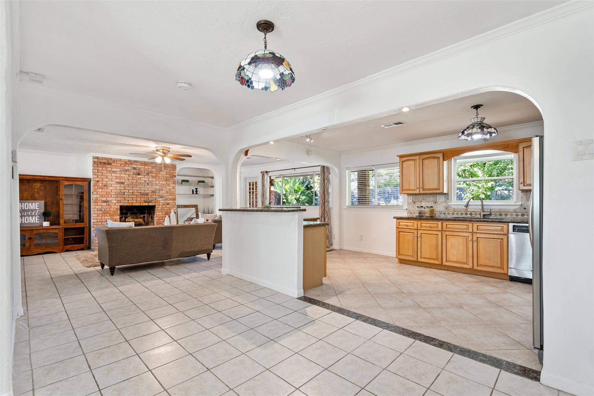 A large hallway joins the living room, kitchen and dining room. This spacious area shows the abundance of natural light that flows throughout this beautiful home.*Home was previously furnished. There is currently no furniture in the home.