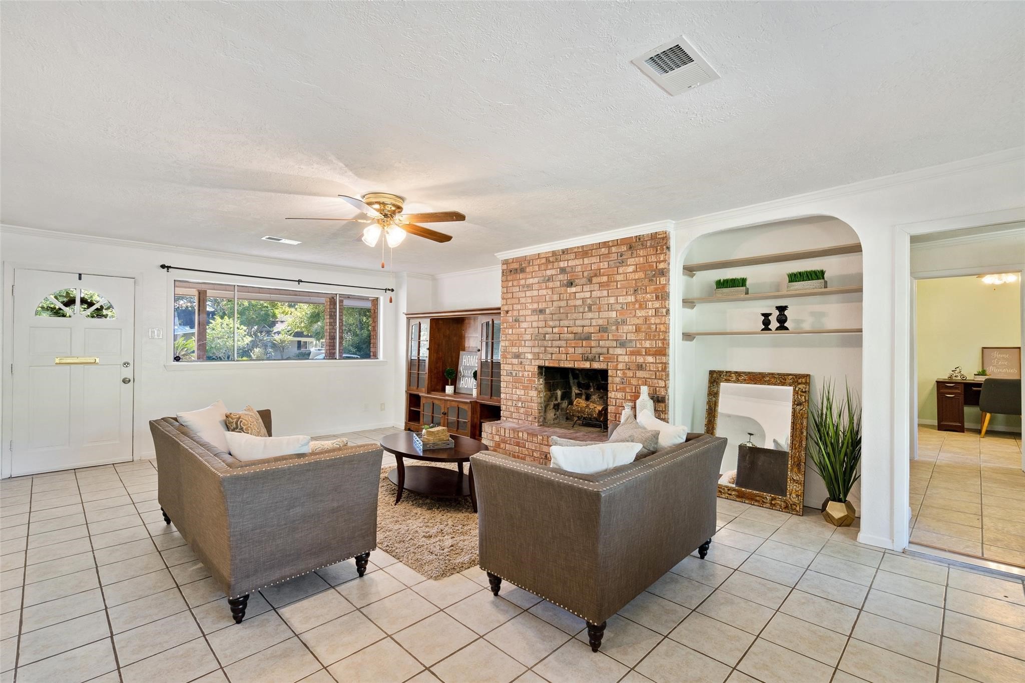 The living room is very welcoming and has large windows on both sides. Natural light flows into this great space from all angles.*Home was previously furnished. There is currently no furniture in the home.