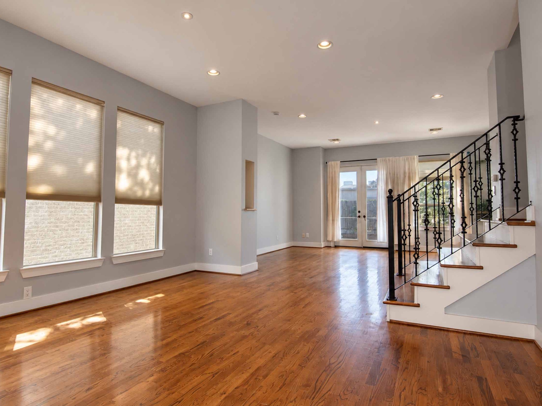 Open concept kitchen, dining and living room with a balcony.