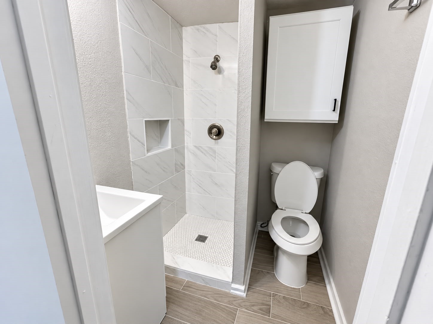 Bathroom with tiled walk-in shower.