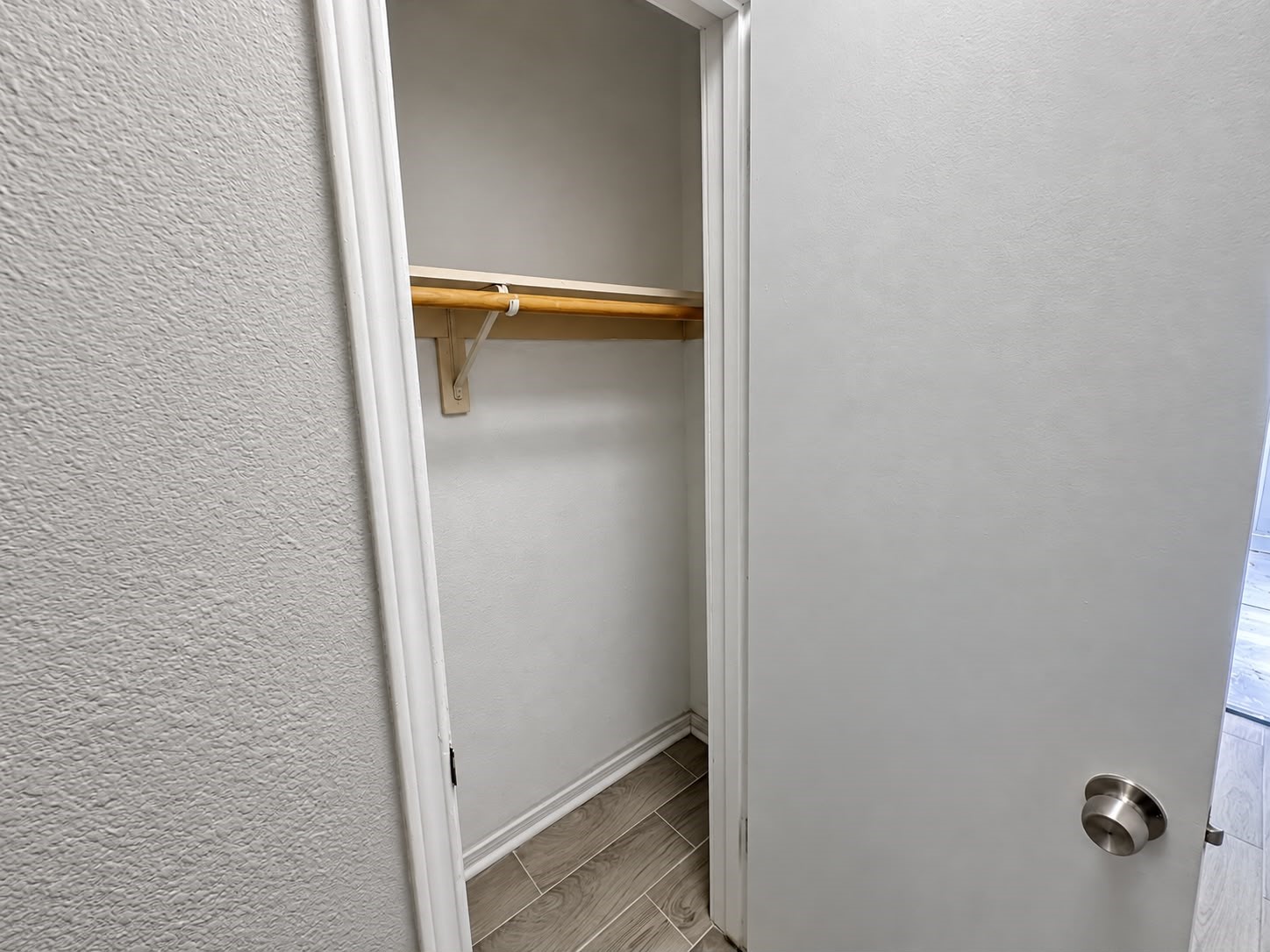Closet with built-in shelf and hanging rod.