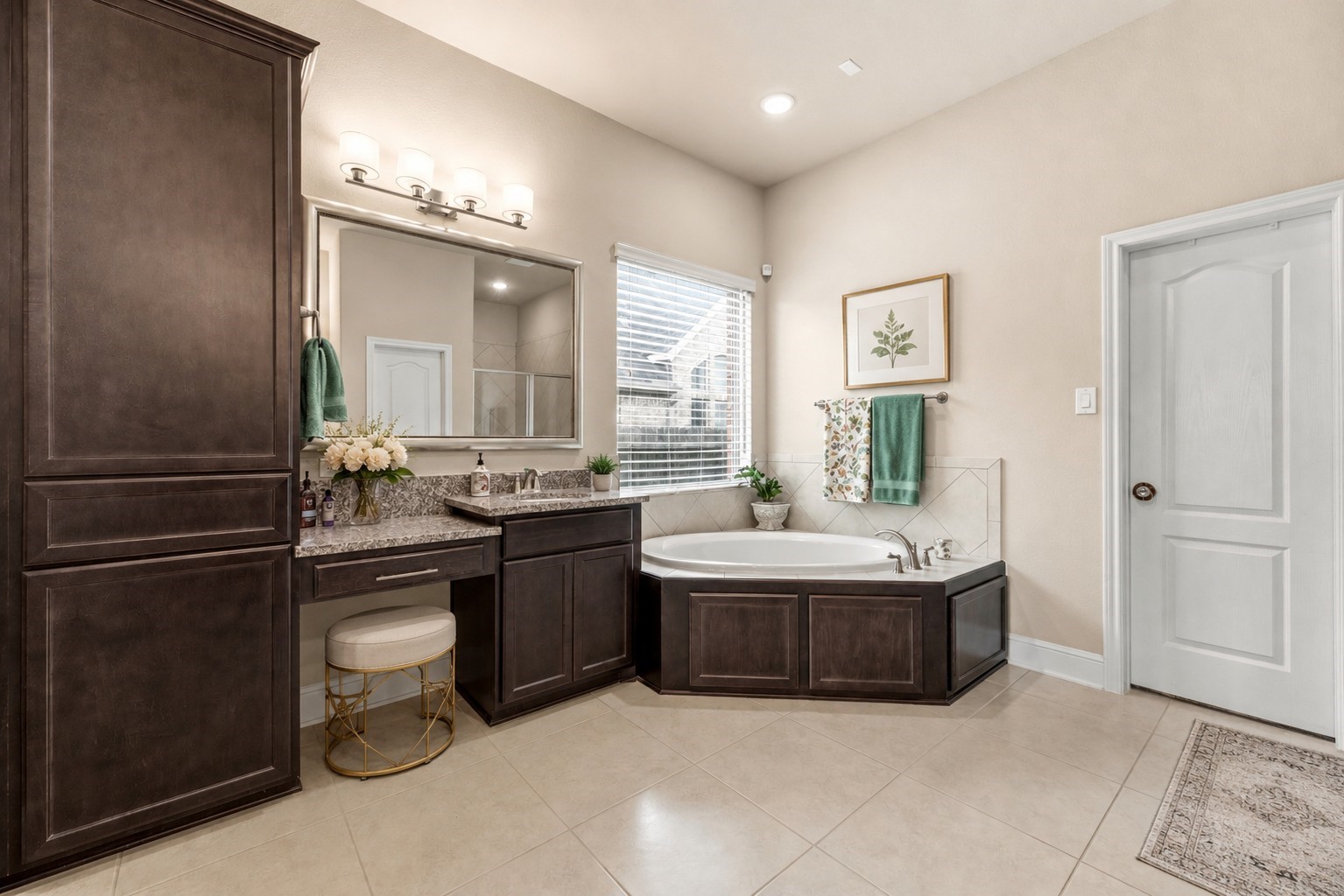 The well appointed primary bath features 2 sinks, one with a vanity area, a soaking tub, and a generously sized shower. (virtually staged)