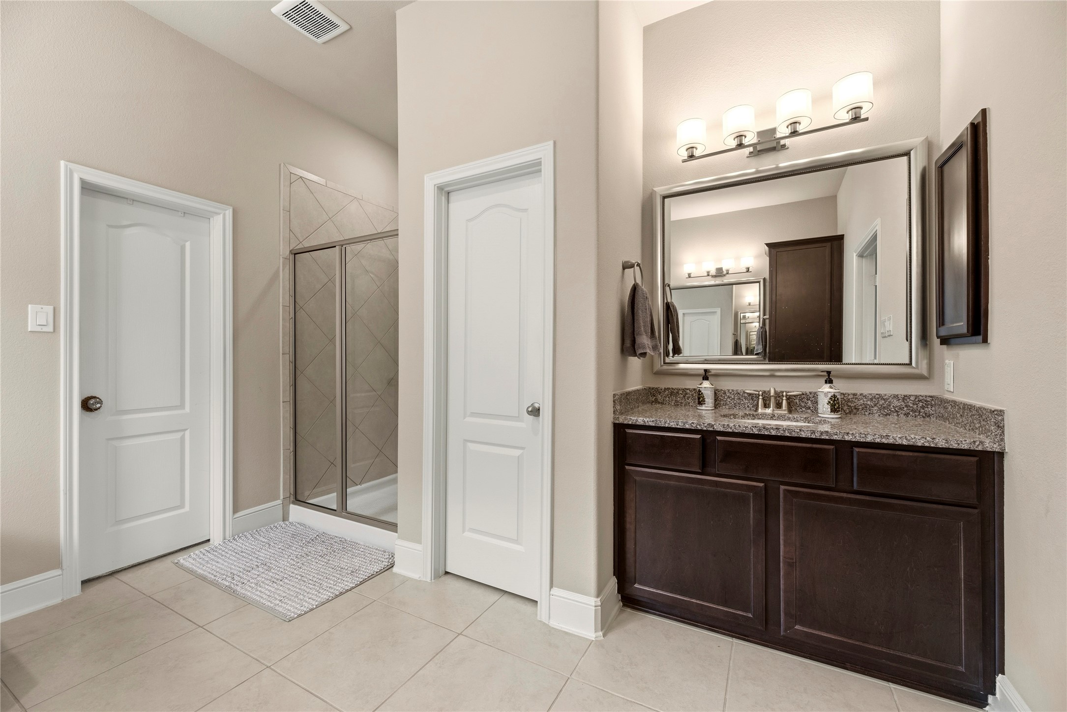 Opposite view of the primary bath. The door on the left of this photo opens into the walk-in closet.