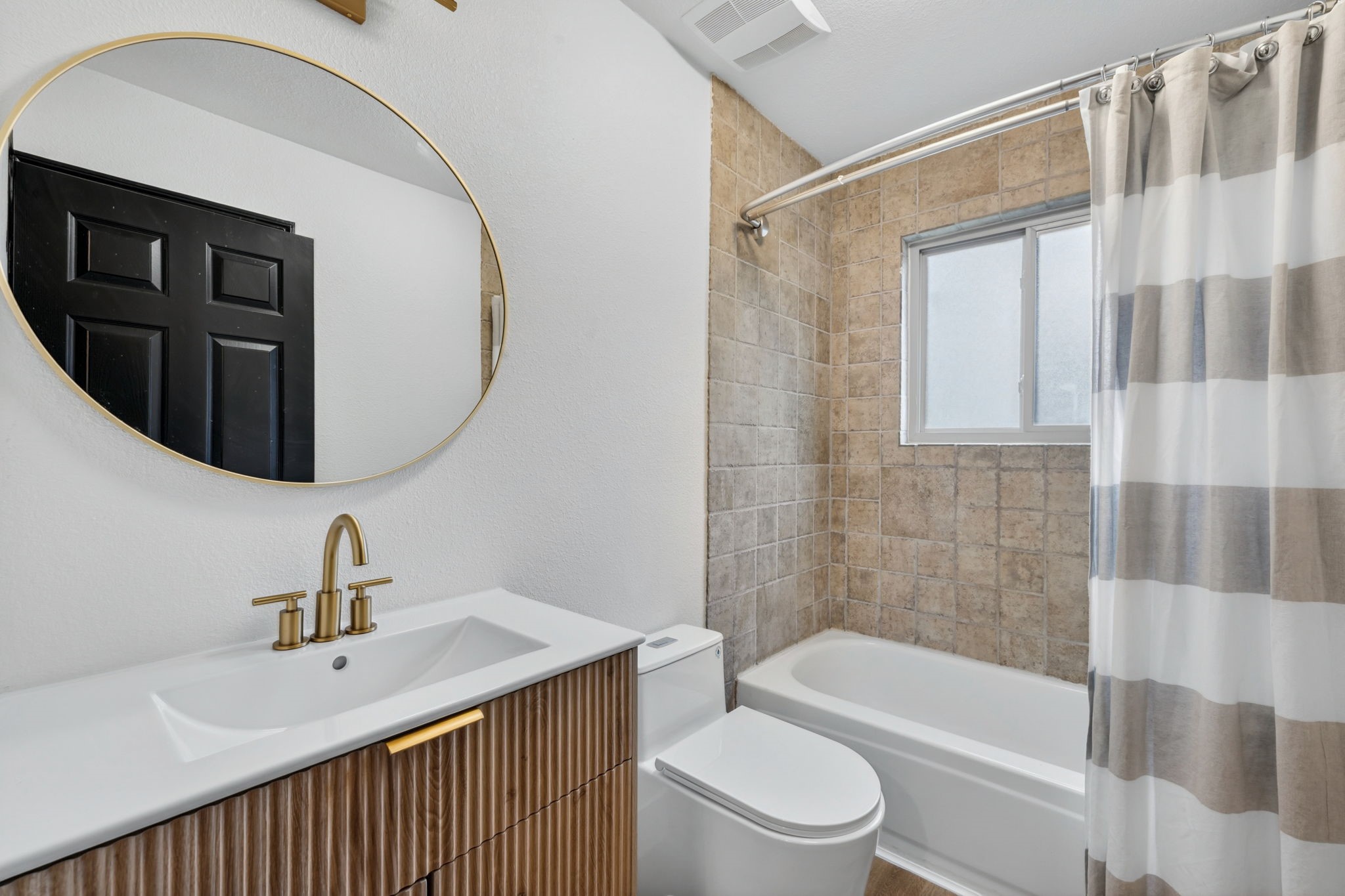 Updated with fluted detailing, gold accents, and a clean timeless finish