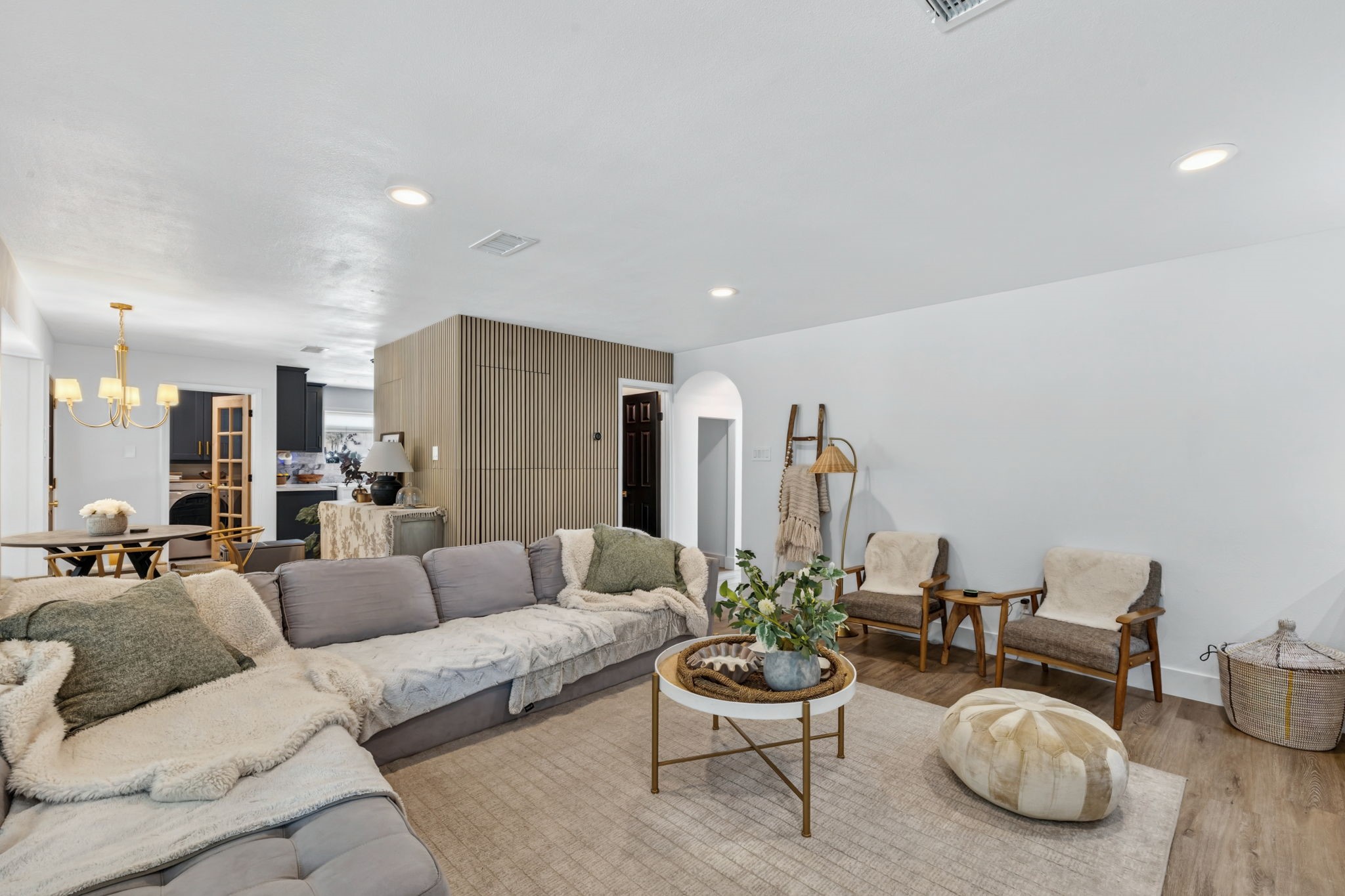 Custom wall detailing adds texture and depth to the living room design