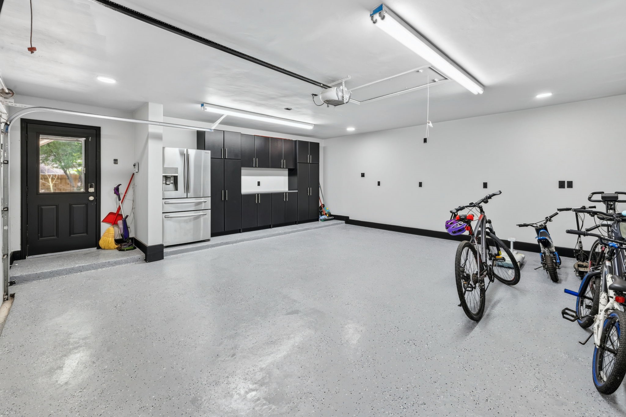 Built-in storage, workspace counters, and a fridge create a garage that feels truly custom