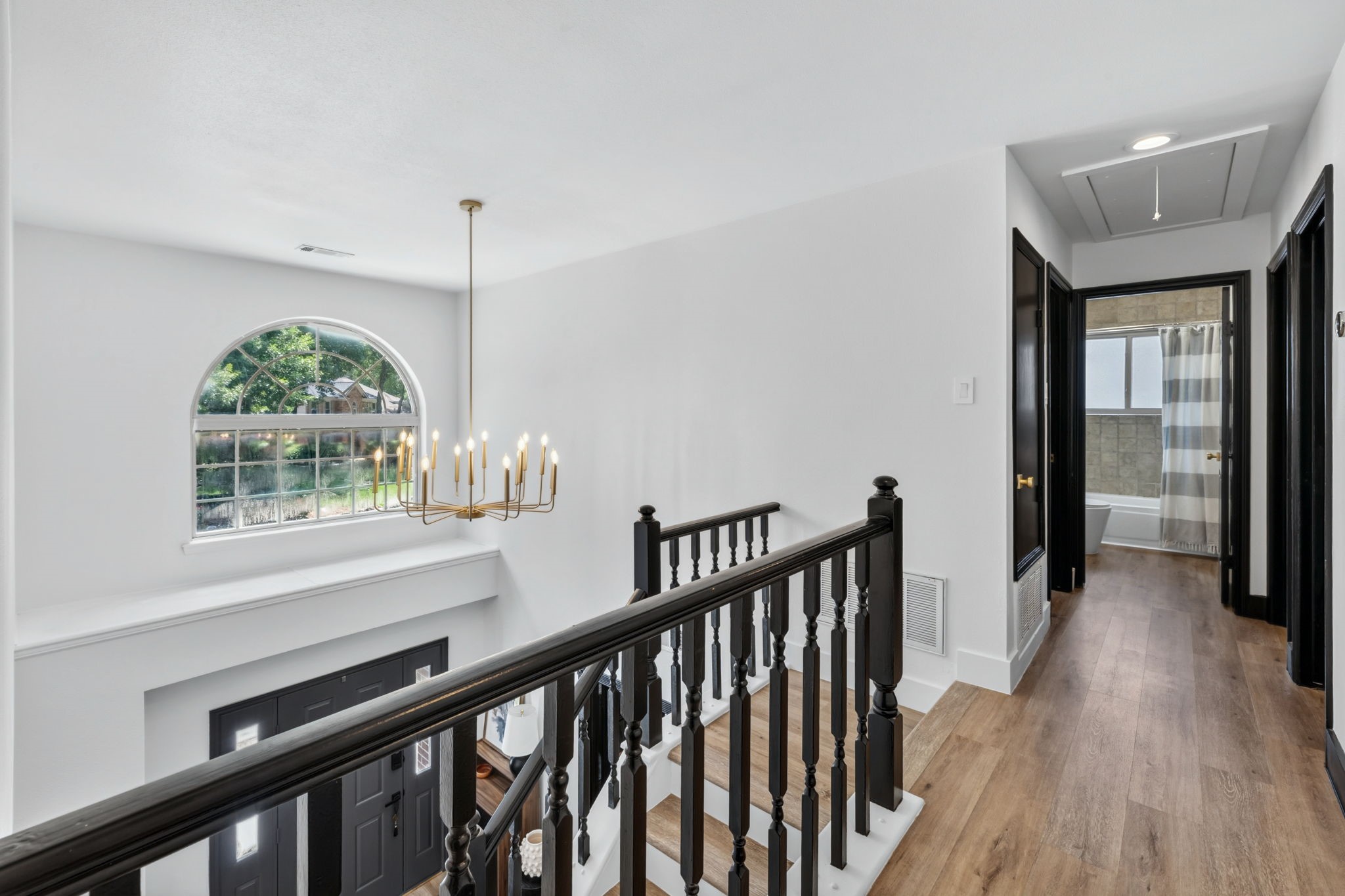 Upstairs, natural light and dramatic lighting details continue the homes design-forward fee
