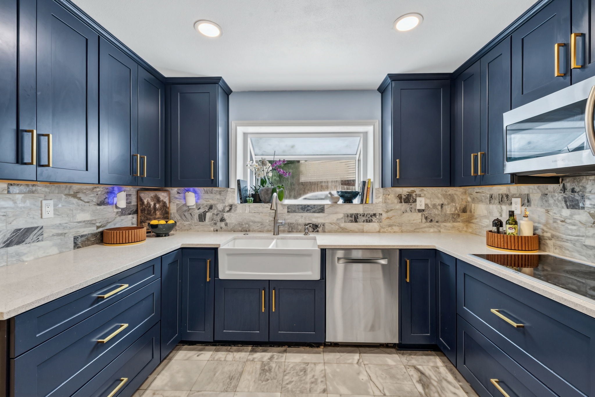 A refreshed kitchen where bold blue cabinetry meets warm gold accents