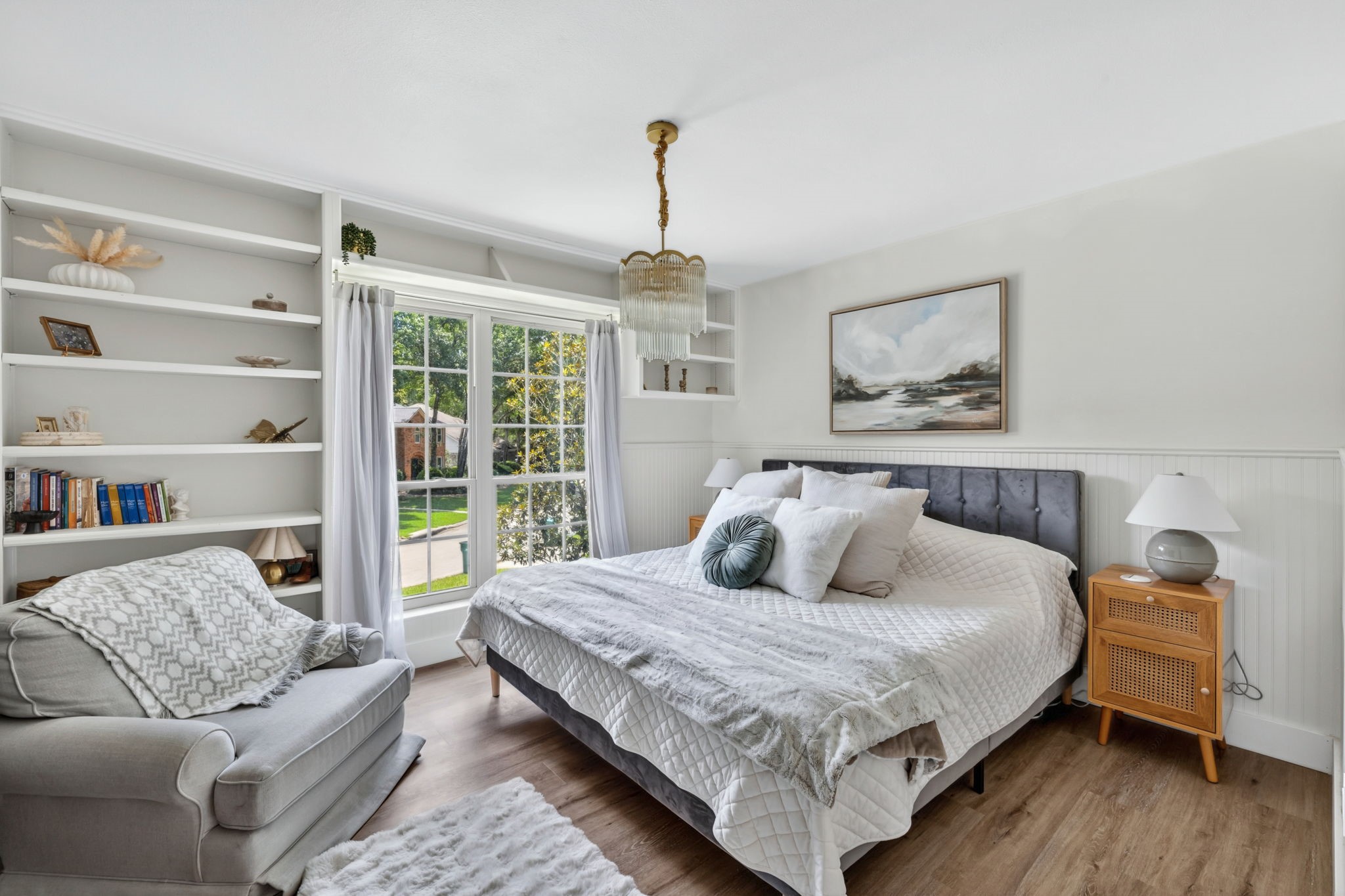 Built-in shelving and natural light make this bedroom feel both cozy and functional