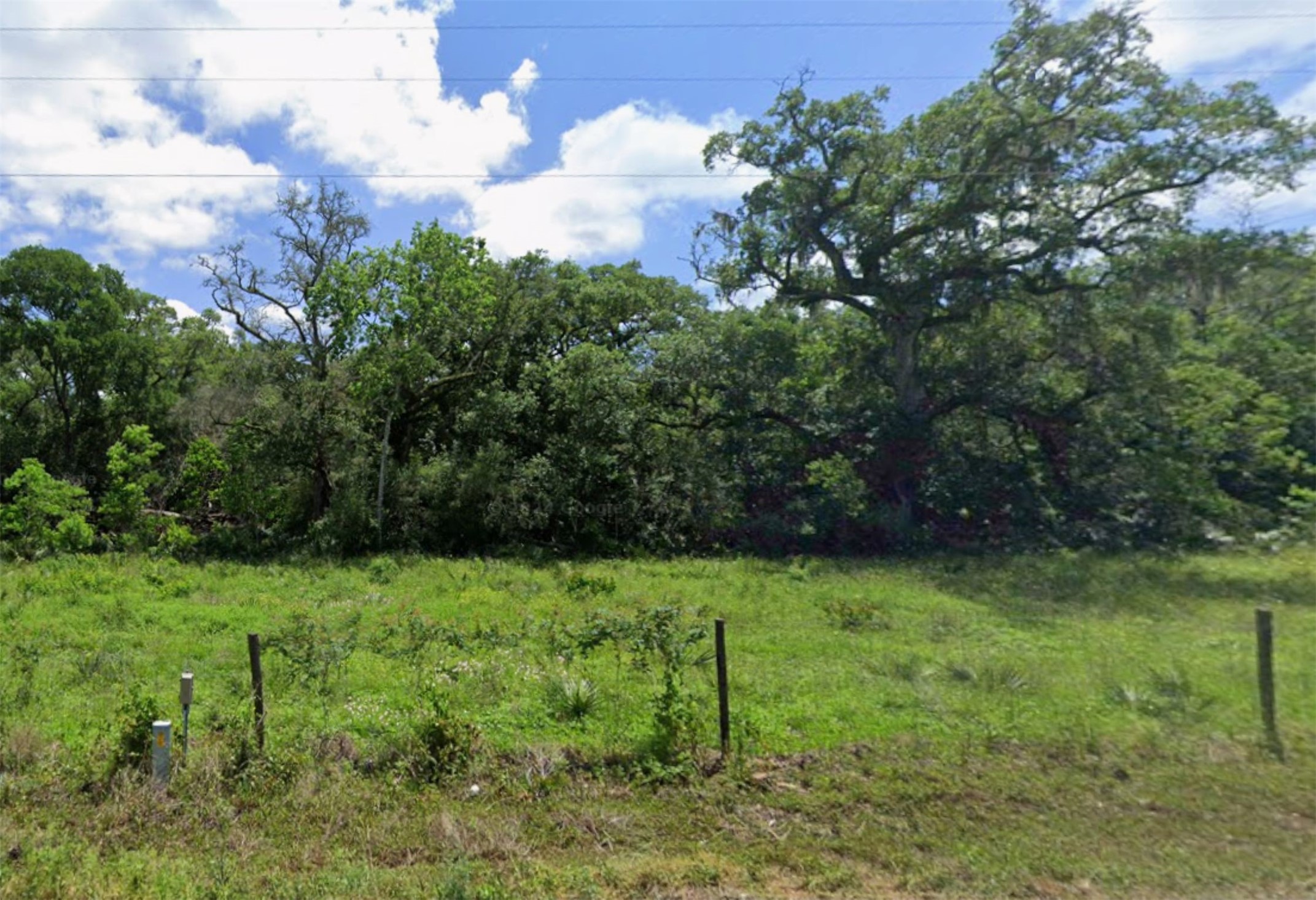 Fully fenced, raw land.