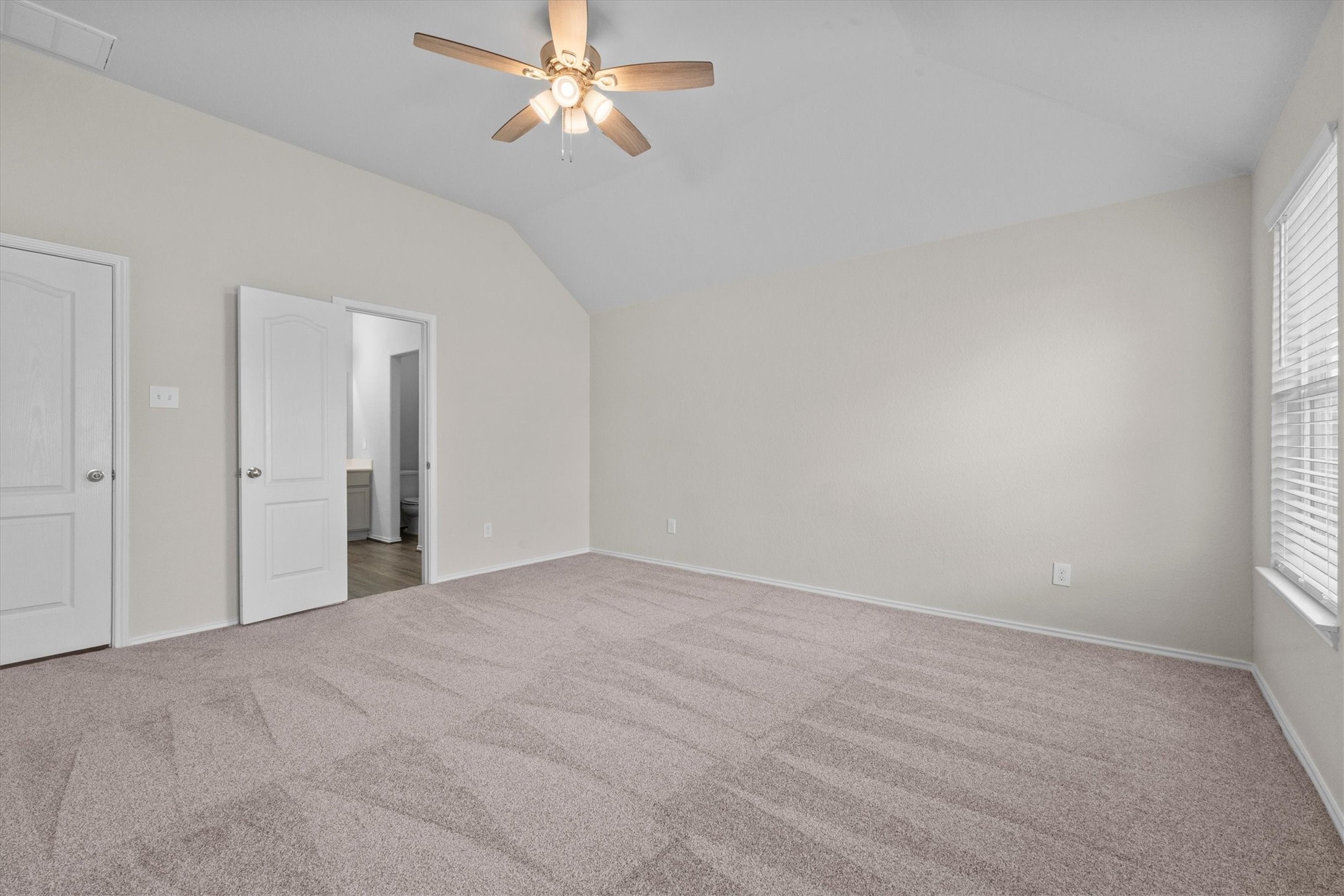 Spacious Primary Bedroom with added ceiling fan