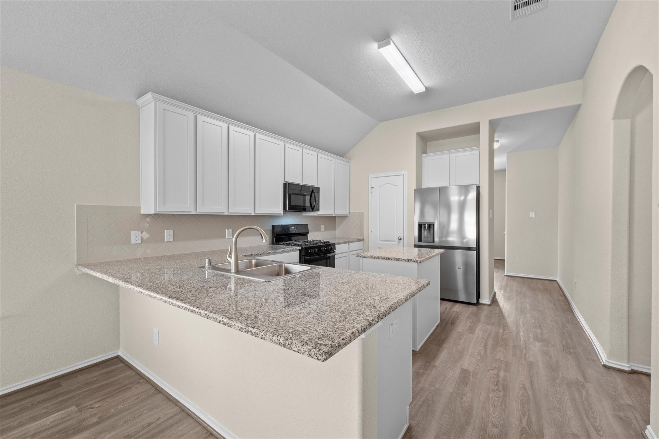 Another angle of the kitchen with breakfast bar Another angle of the kitchen with breakfast bar