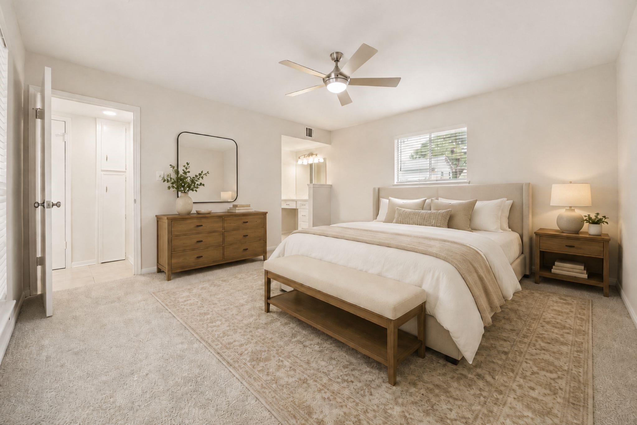 THE GENEROUS PRIMARY BEDROOM FEATURES A CEILING FAN, MULTIPLE WINDOWS, AND DIRECT ACCESS TO THE EN SUITE BATH. **Virtually Staged.