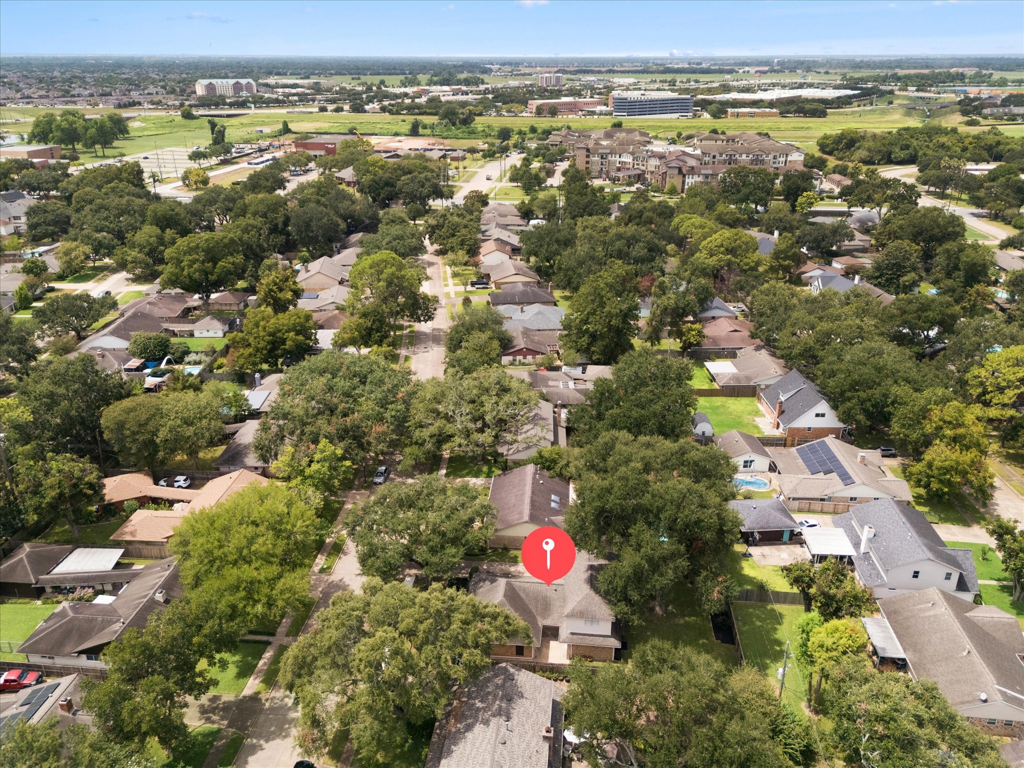 THE SPACIOUS BACKYARD OFFERS A LARGE LAWN, MATURE SHADE TREES, AND PLENTY OF ROOM FOR OUTDOOR LIVING OR PLAY.