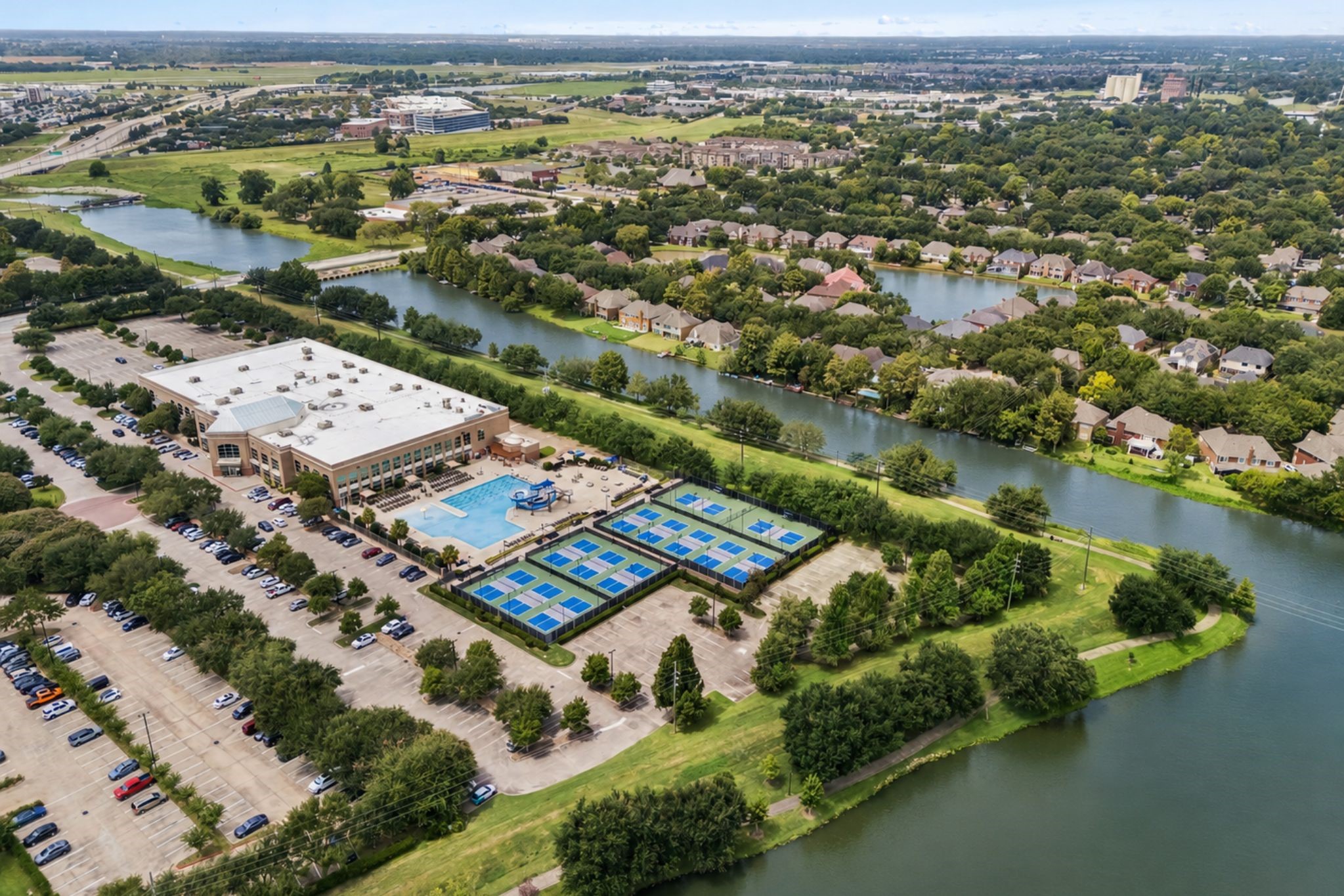 AERIAL VIEW HIGHLIGHTS THE HOMES ESTABLISHED SUGAR LAND SETTING, SURROUNDED BY MATURE TREES AND CONVENIENT CITY ACCESS.
