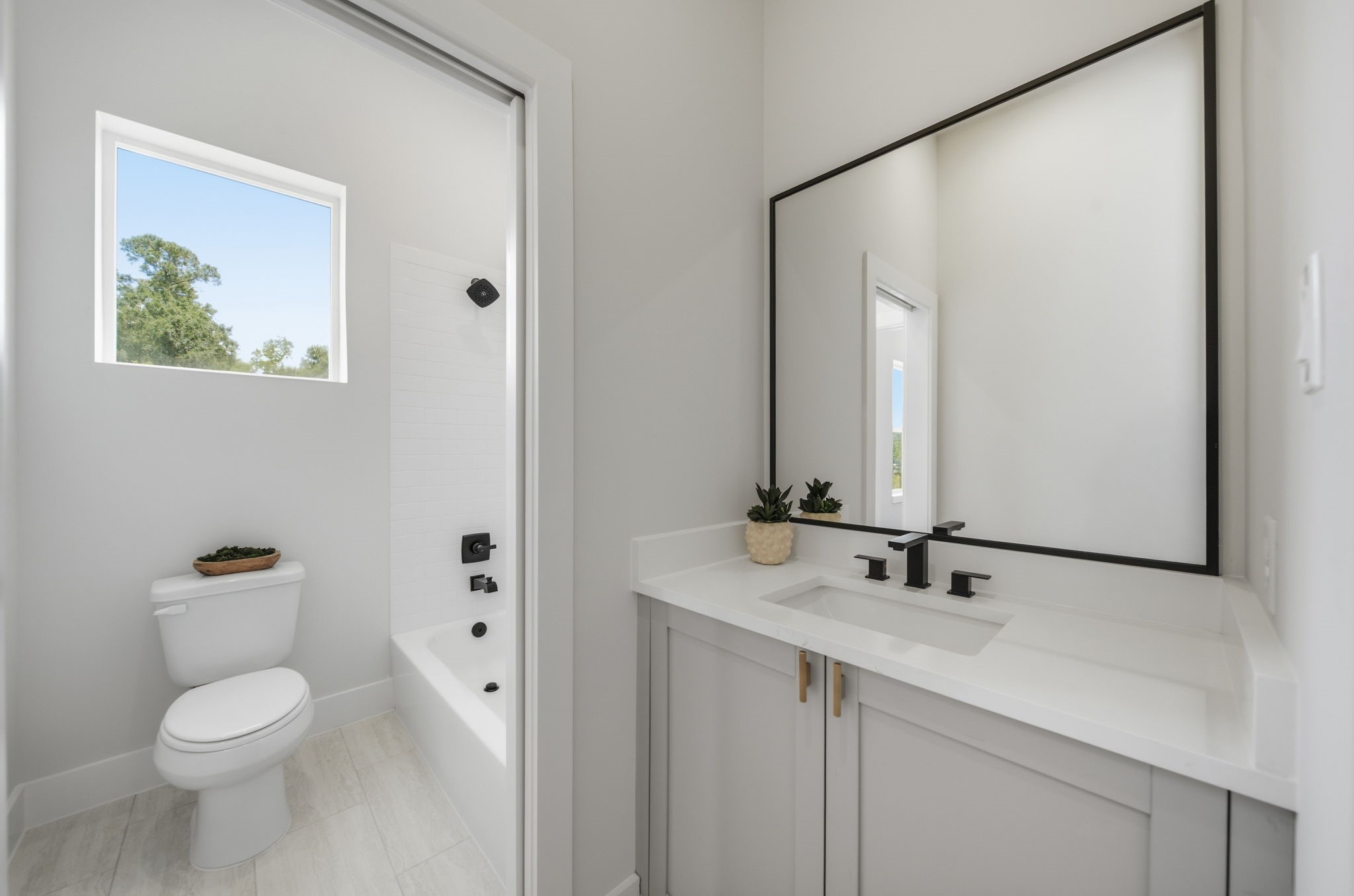 Jack and jill full bathroom upstairs with separated vanity areas for each room