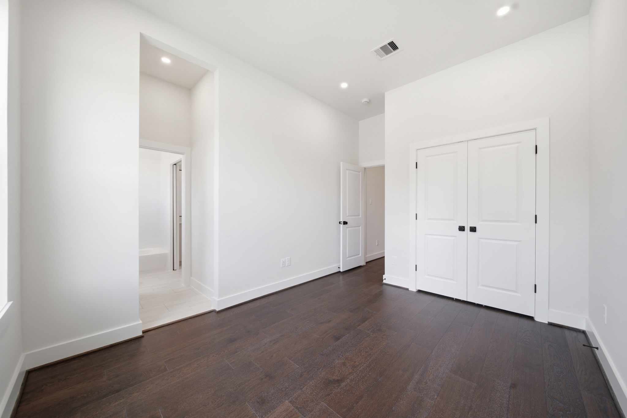 Secondary bedroom with closet and attached full bathroom