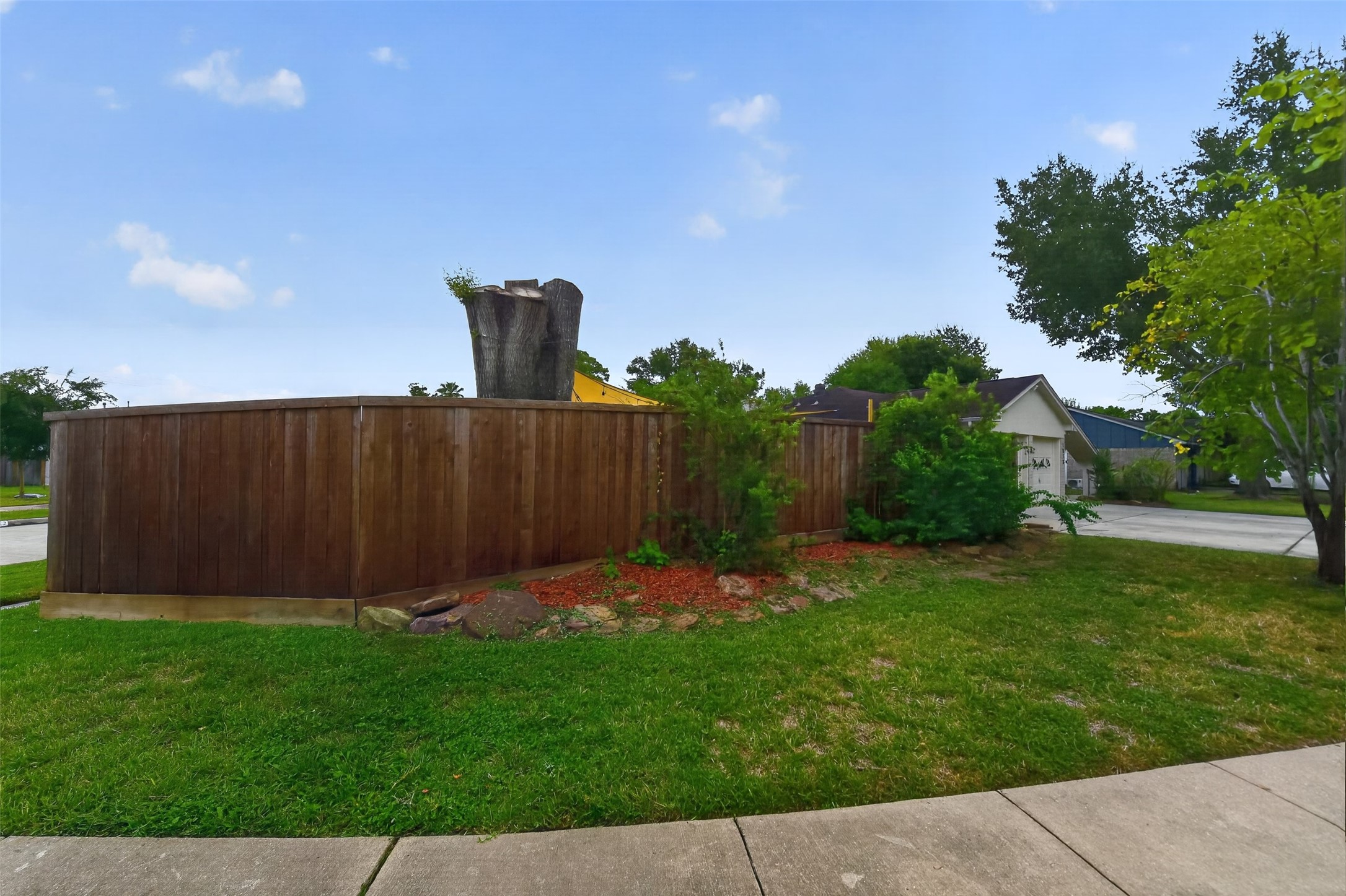 Corner lot has lots of green space for kicking a soccer ball or tossing a baseball.