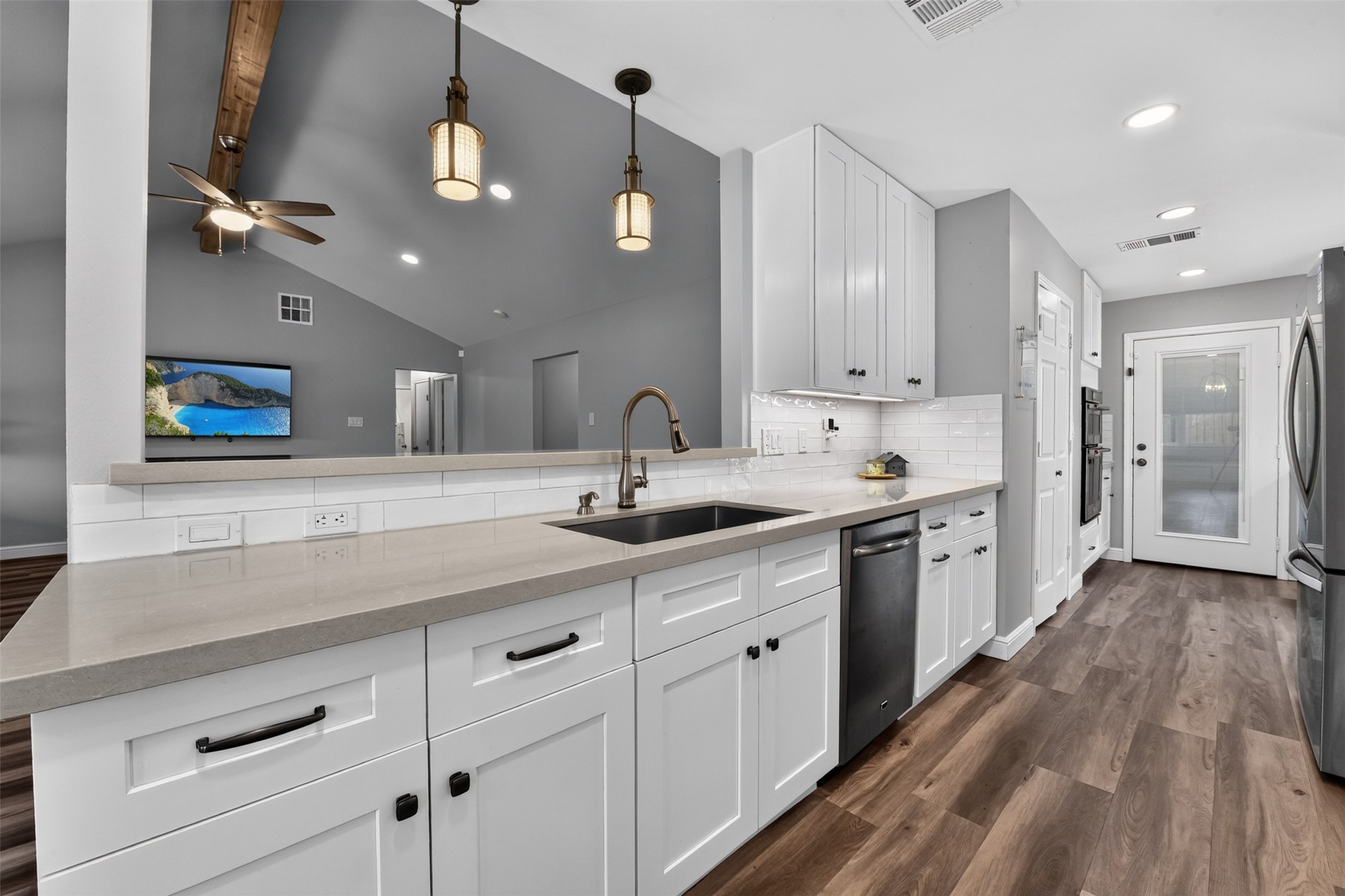 You won't miss any of the activity in the living room while working in this kitchen.