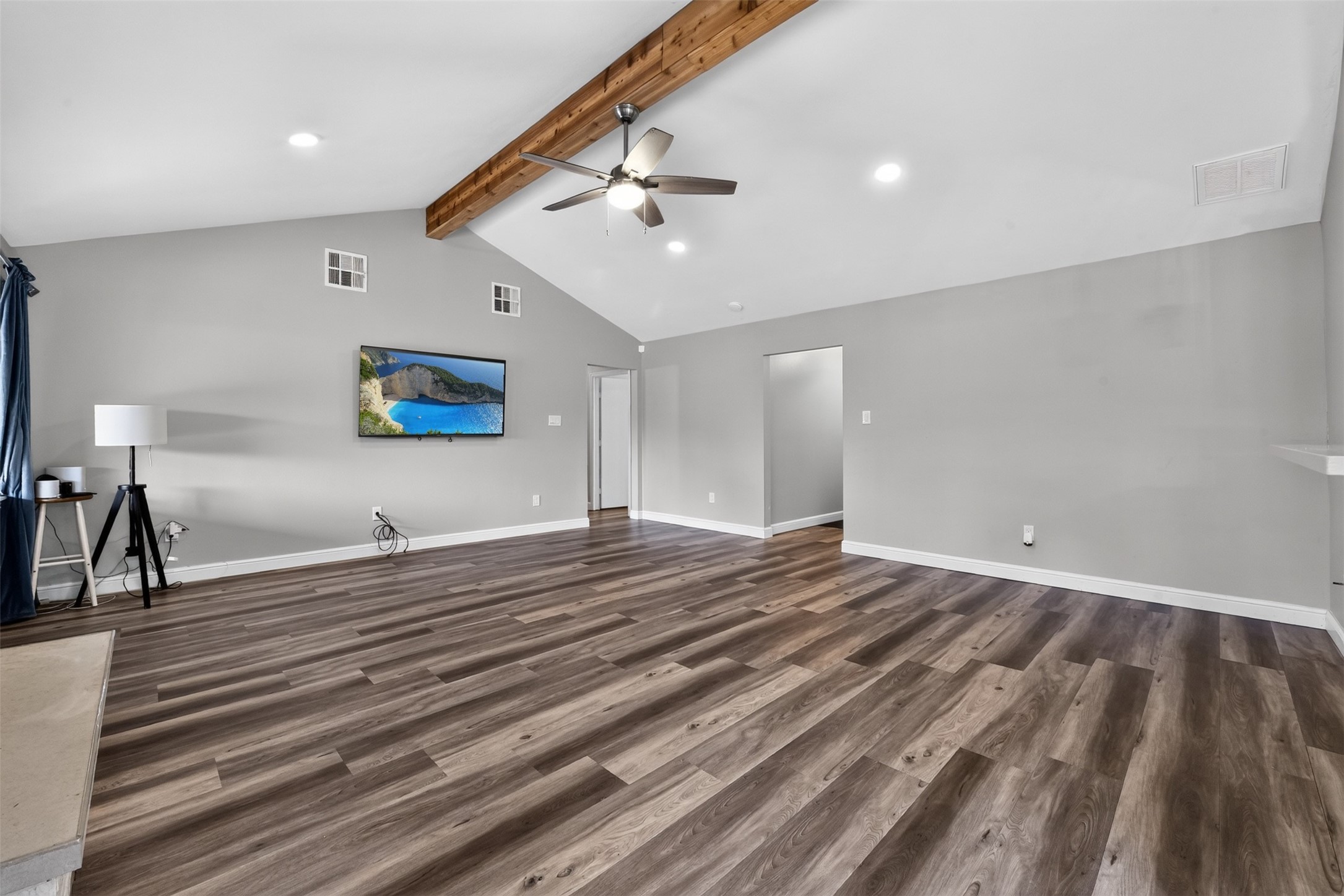 Step inside to see the open living area with high vaulted ceiling and luxury vinyl flooring. Step inside to see the open living area with high vaulted ceiling and luxury vinyl flooring.