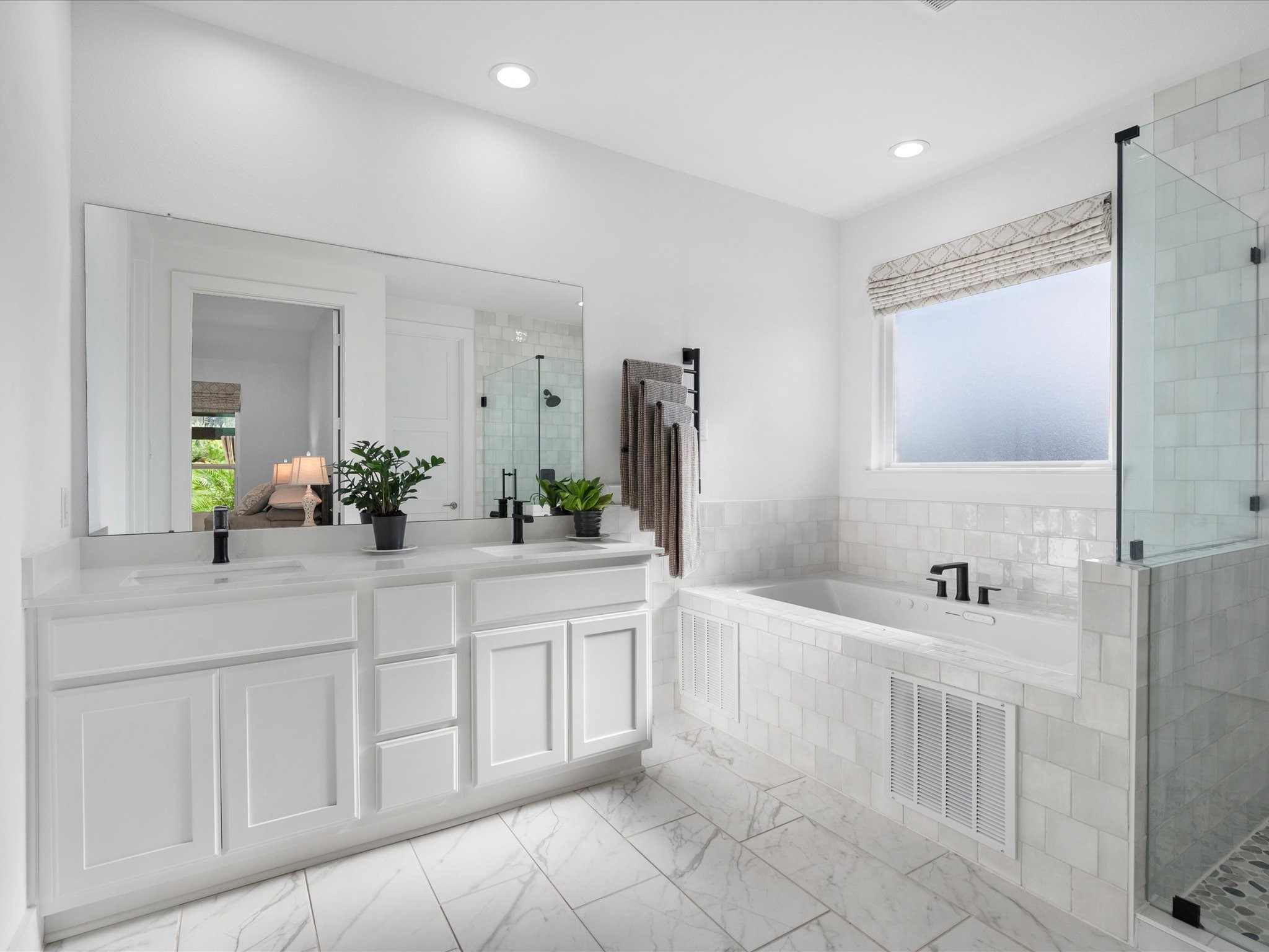 Primary bathroom with masterfully transformed spa tub & shower & remote controlled blinds
