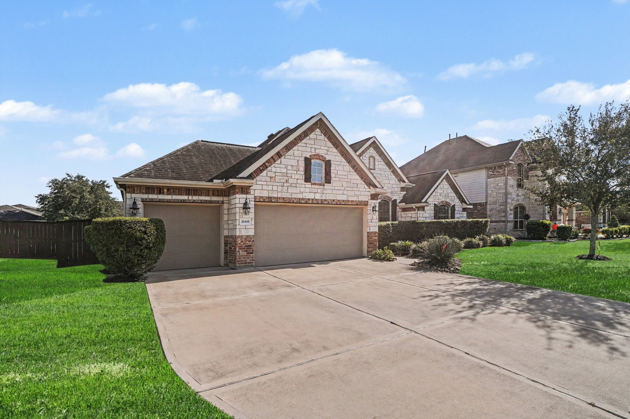 Features a generous double garage alongside a separate single garage bay, providing ample space for parking, storage, or a workshop, complete with an extra-wide concrete driveway.