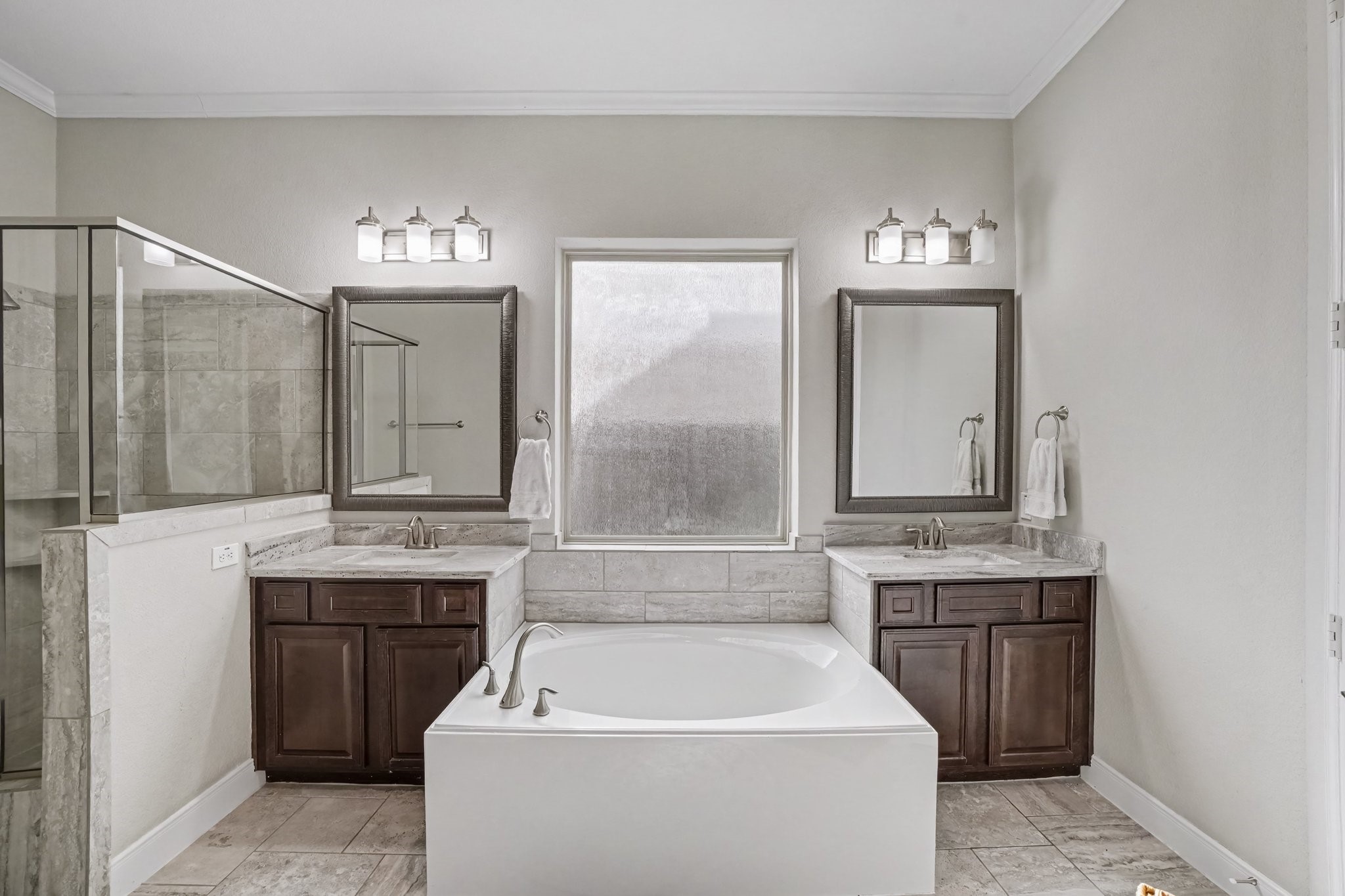 Indulge in a spa-like retreat within this luxurious ensuite primary bathroom, thoughtfully designed for relaxation and comfort.