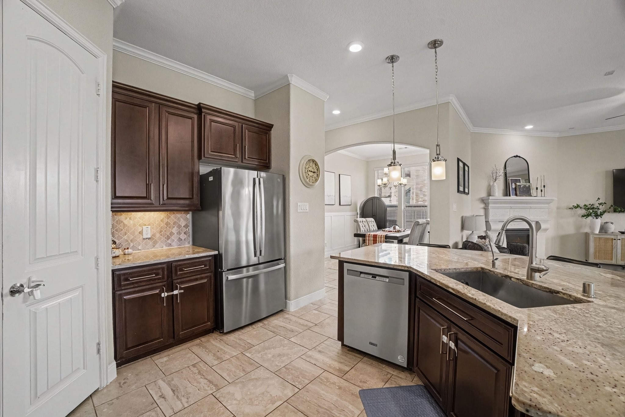 Adjacent to the refrigerator, a spacious walk-in pantry pantry door provides convenient food storage right within reach.