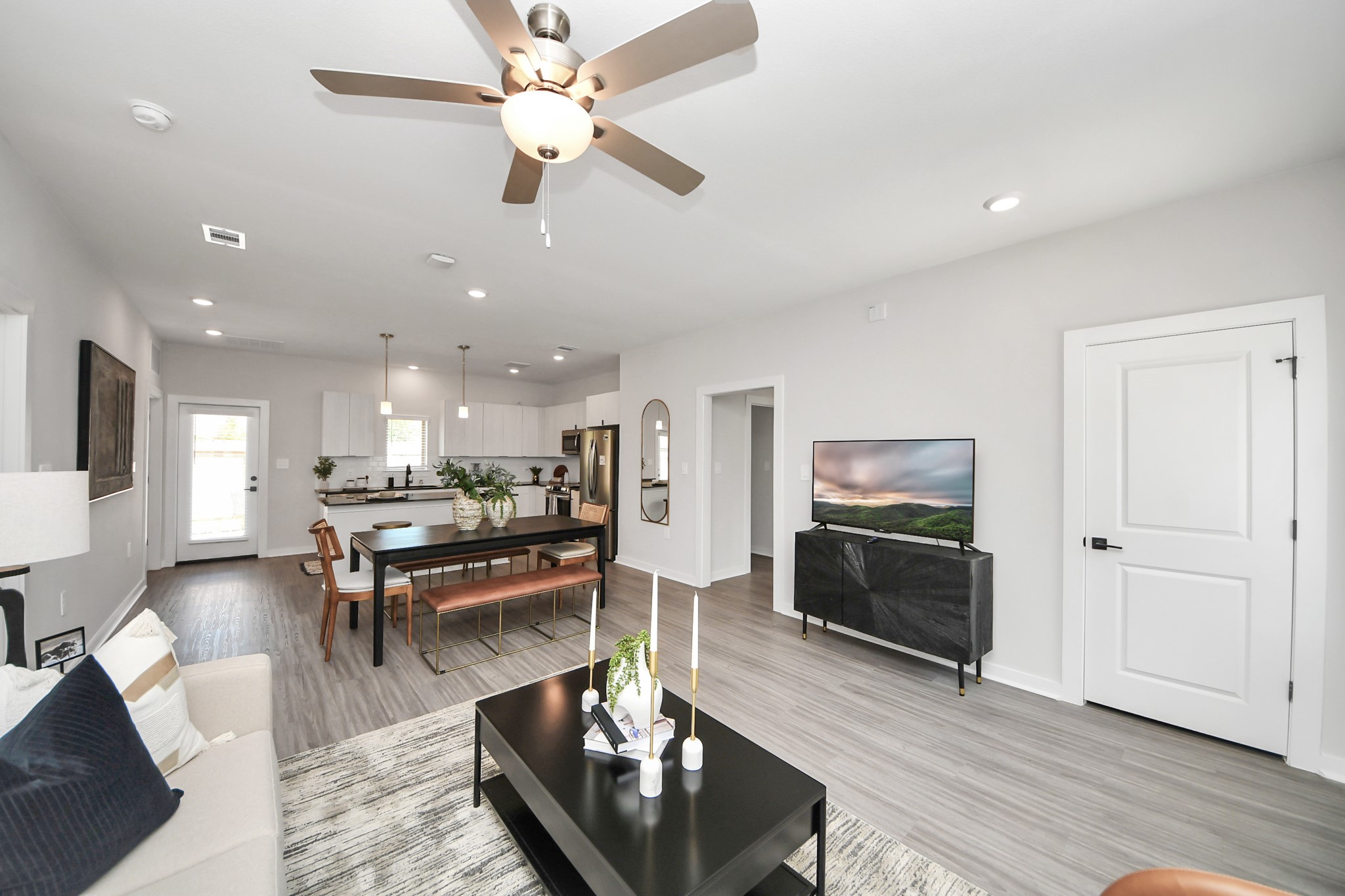 Boasting luxury finishes-stylish Island kitchen,granite counters,subway tile backsplash,ample custom cabinet space,stainless appliances,refrigerator,full size washer&dryer included,wood-like flooring throughout,open concept floor plan.
