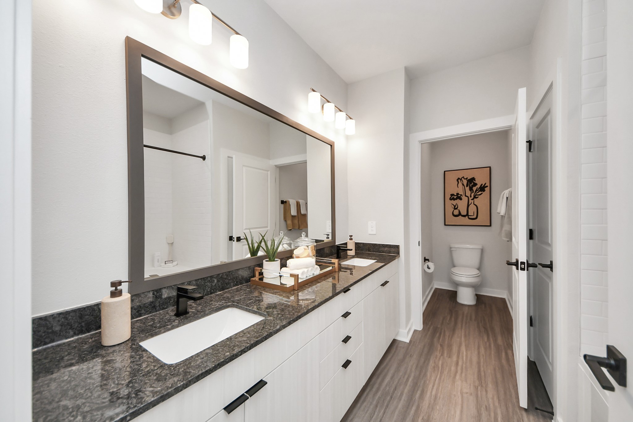 Primary Suite offers walk-closet,bath w/dual vanities&lux tub/shower.