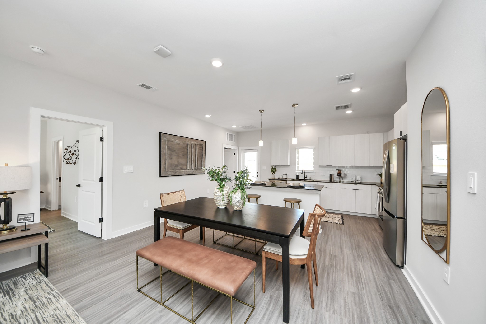 Boasting luxury finishes-stylish Island kitchen,granite counters,subway tile backsplash,ample custom cabinet space,stainless appliances,refrigerator,full size washer&dryer included,wood-like flooring throughout,open concept floor plan.