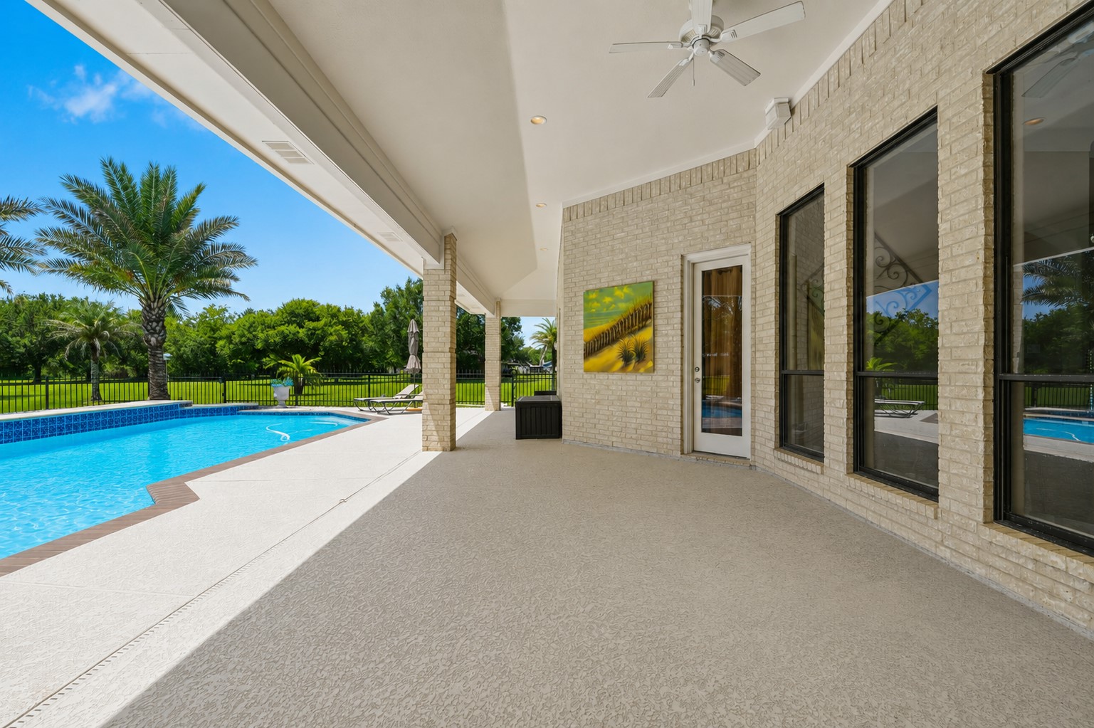 Expansive covered outdoor living area with pool views