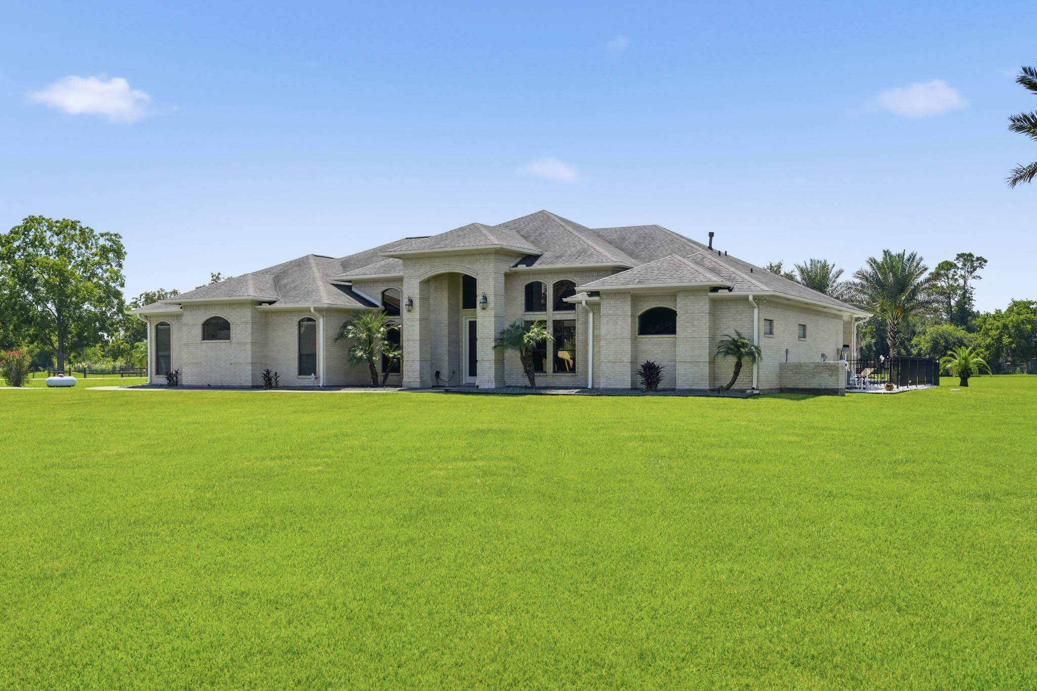 Wide front view showcasing the home and spacious grounds