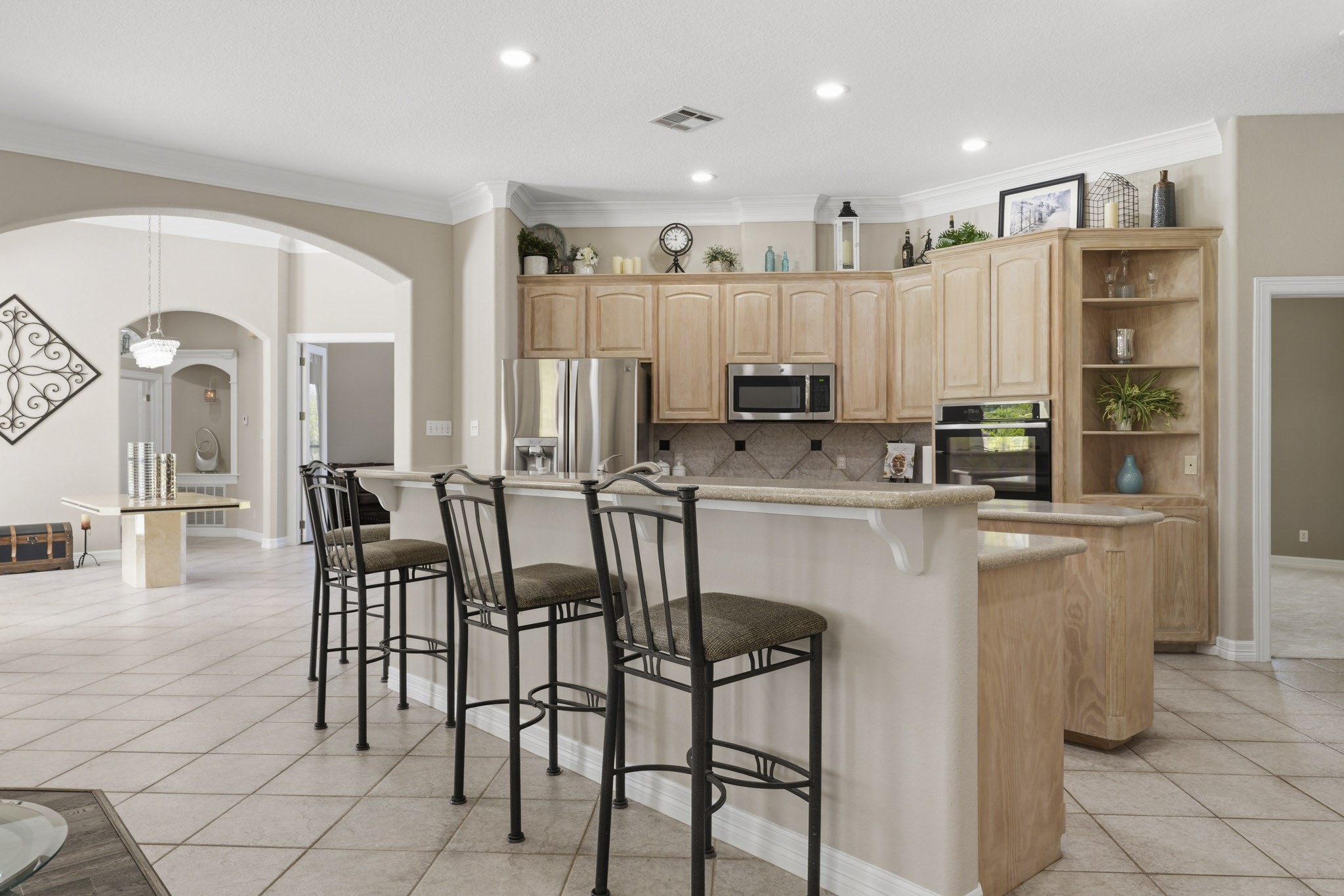 Spacious kitchen with abundant cabinetry and breakfast bar seating