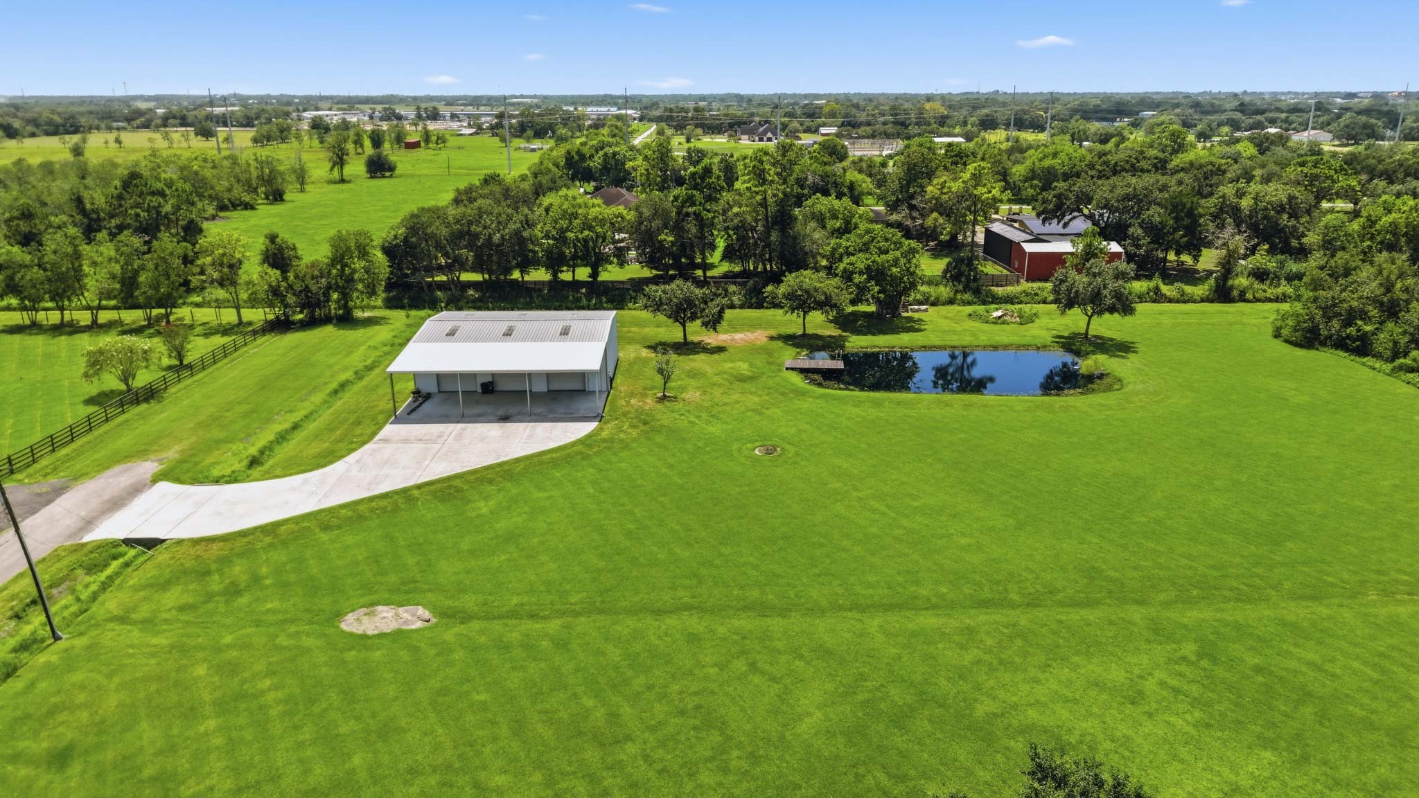 Aerial view highlighting the detached shop and expansive grounds