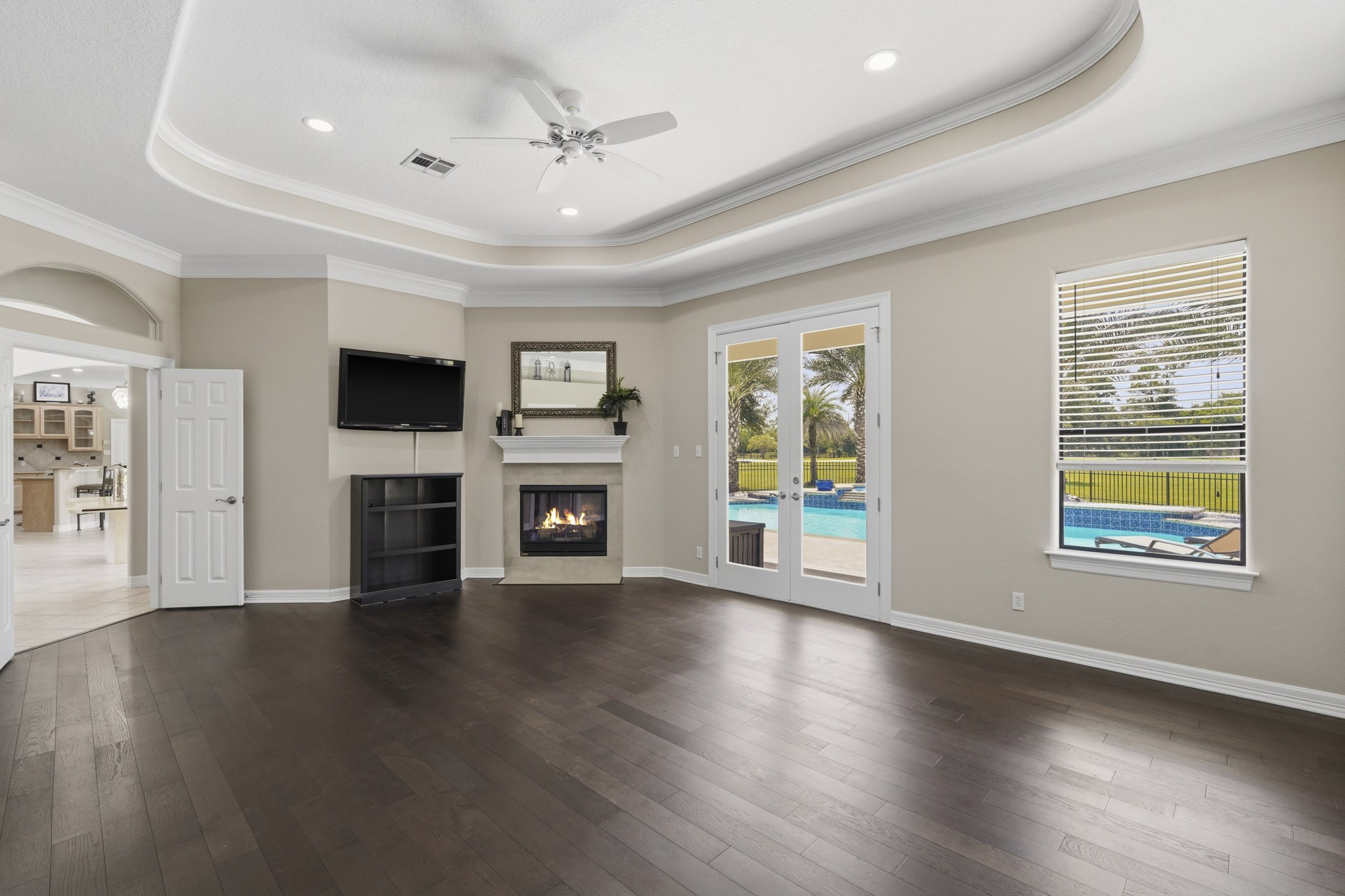 Primary bedroom features fireplace and French doors to the outdoors