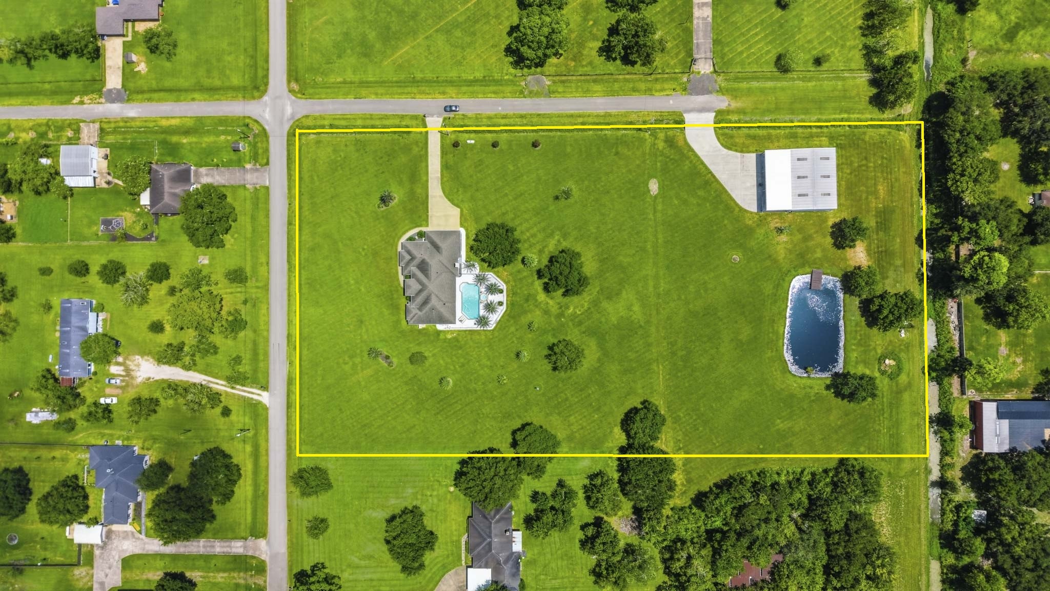 Top-down aerial showcasing the full property layout and surrounding area